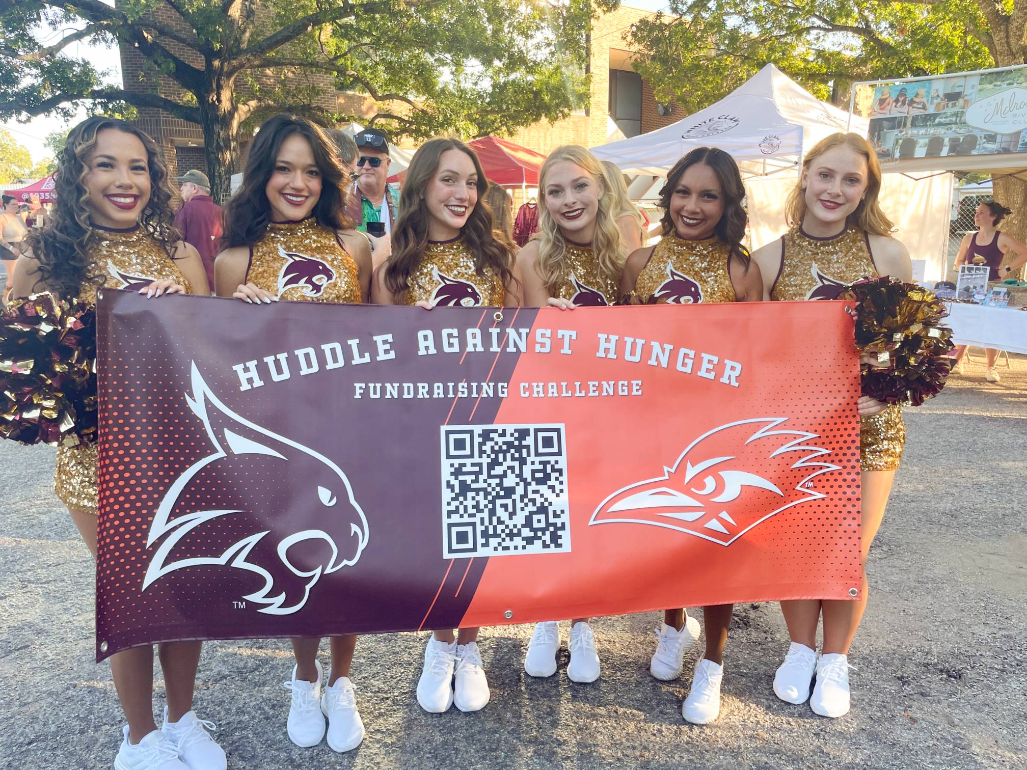 cheerleaders holding a sign