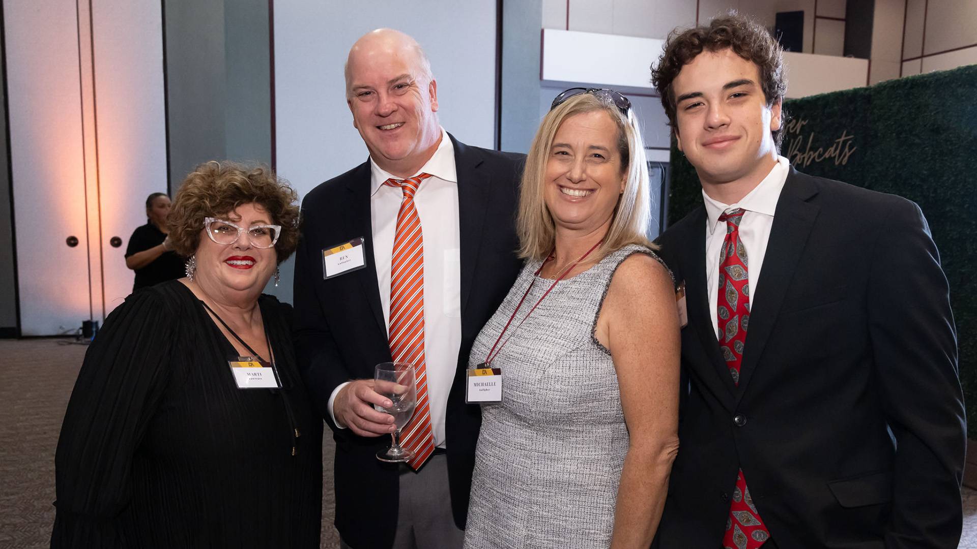 Four guests at the DA gala reception smiling