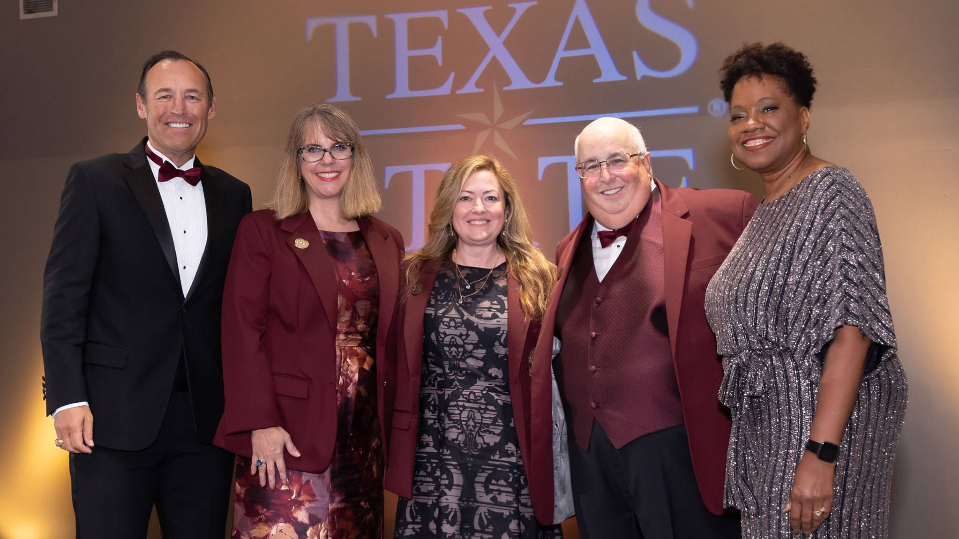 Texas State President Kelly Damphousse, Alumni Association President Tracy Parker, and the three 2023 distinguished alums in their maroon coats