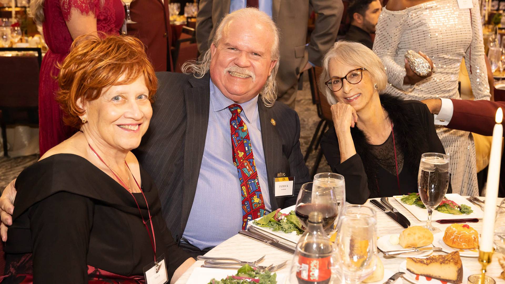 Three guests at a table during the DA gala