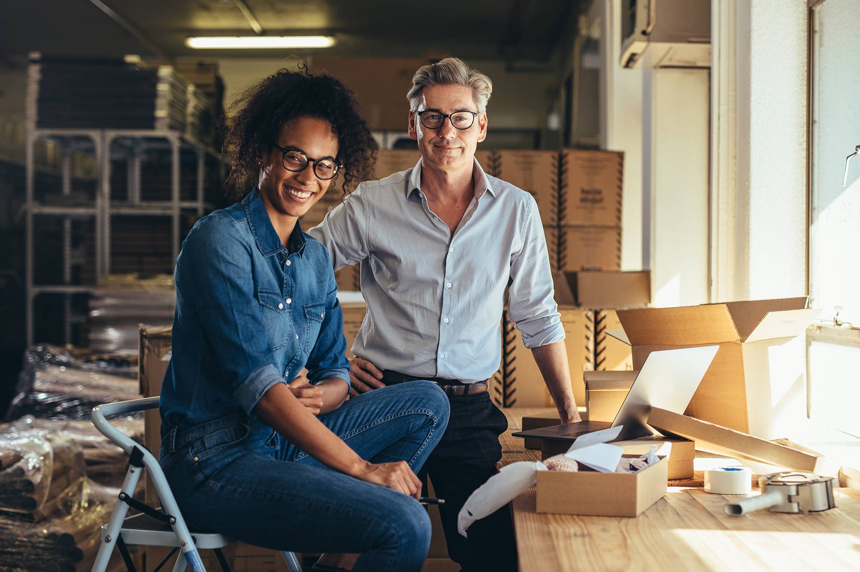 Two business owners in a factory wharehouse.