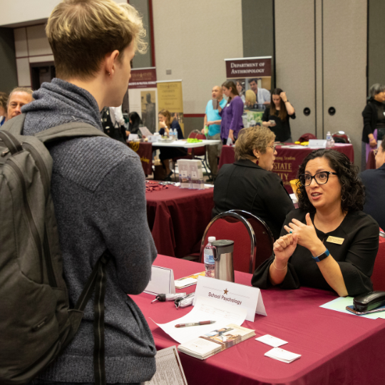 A student talking to a representative at a career fair