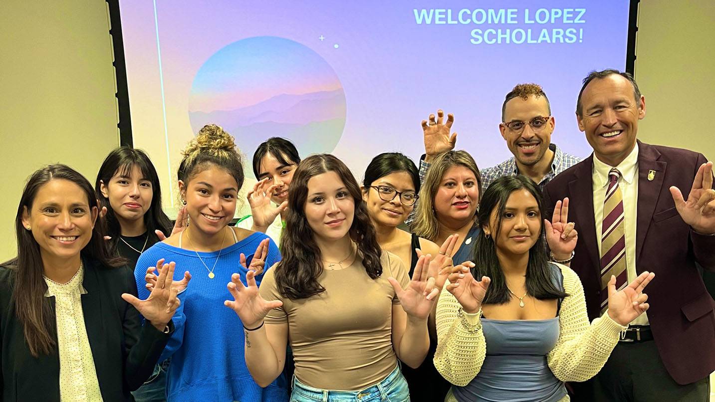 President Kelly Damphousse (right) poses for a photo with Lopez Scholars.