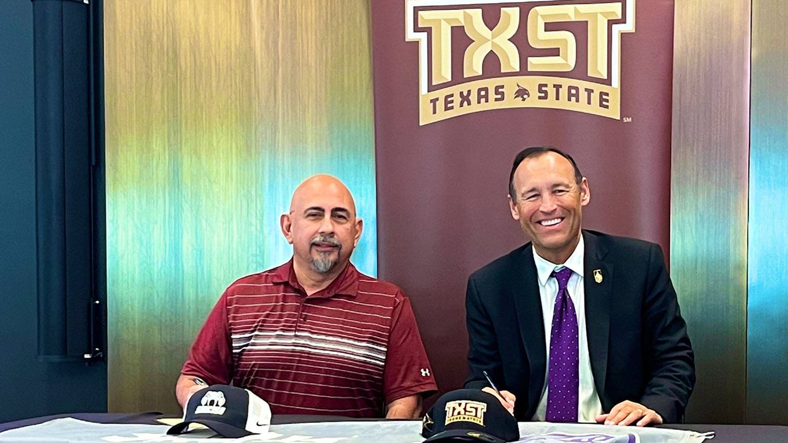 San Marcos CISD Superintendent Michael Cardona (left) and TXST President Kelly Damphousse pose for a photo together at the signing ceremony.