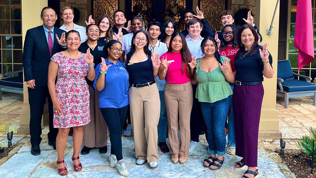 President Kelly Damphousse (left) poses for a photo with the Student Communication Advisory Board.