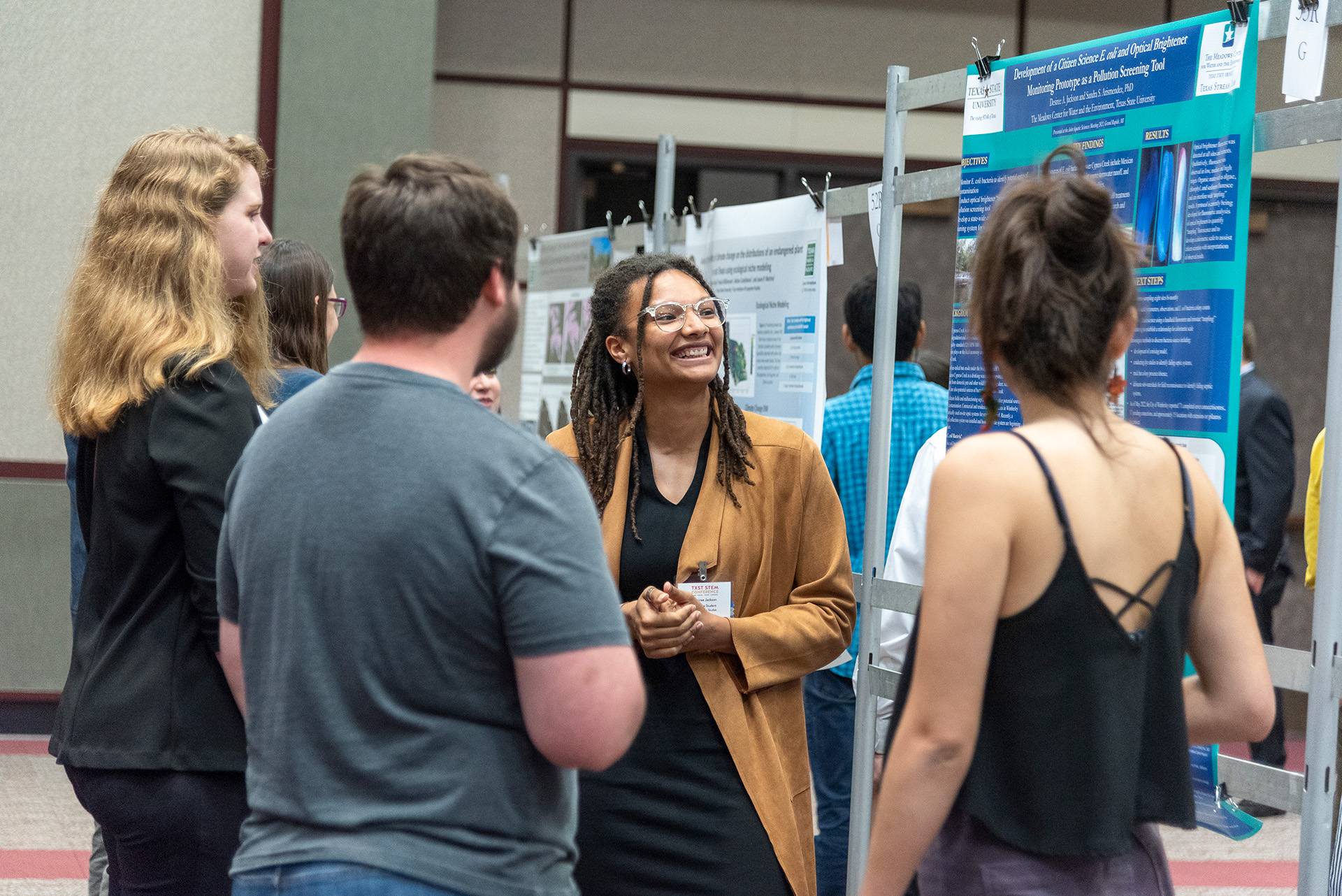 people looking at a research poster