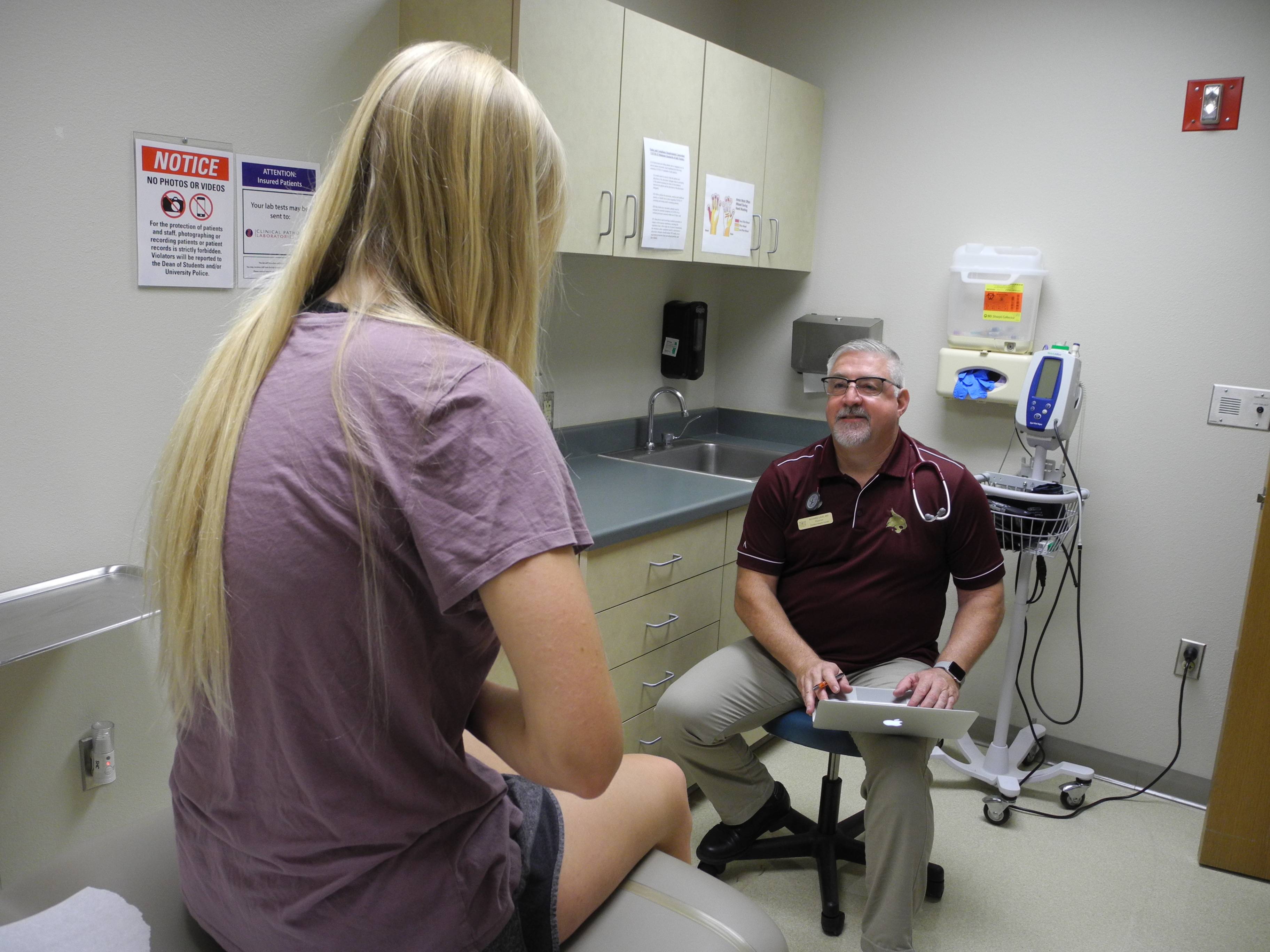 A student speaks to their healthcare provider