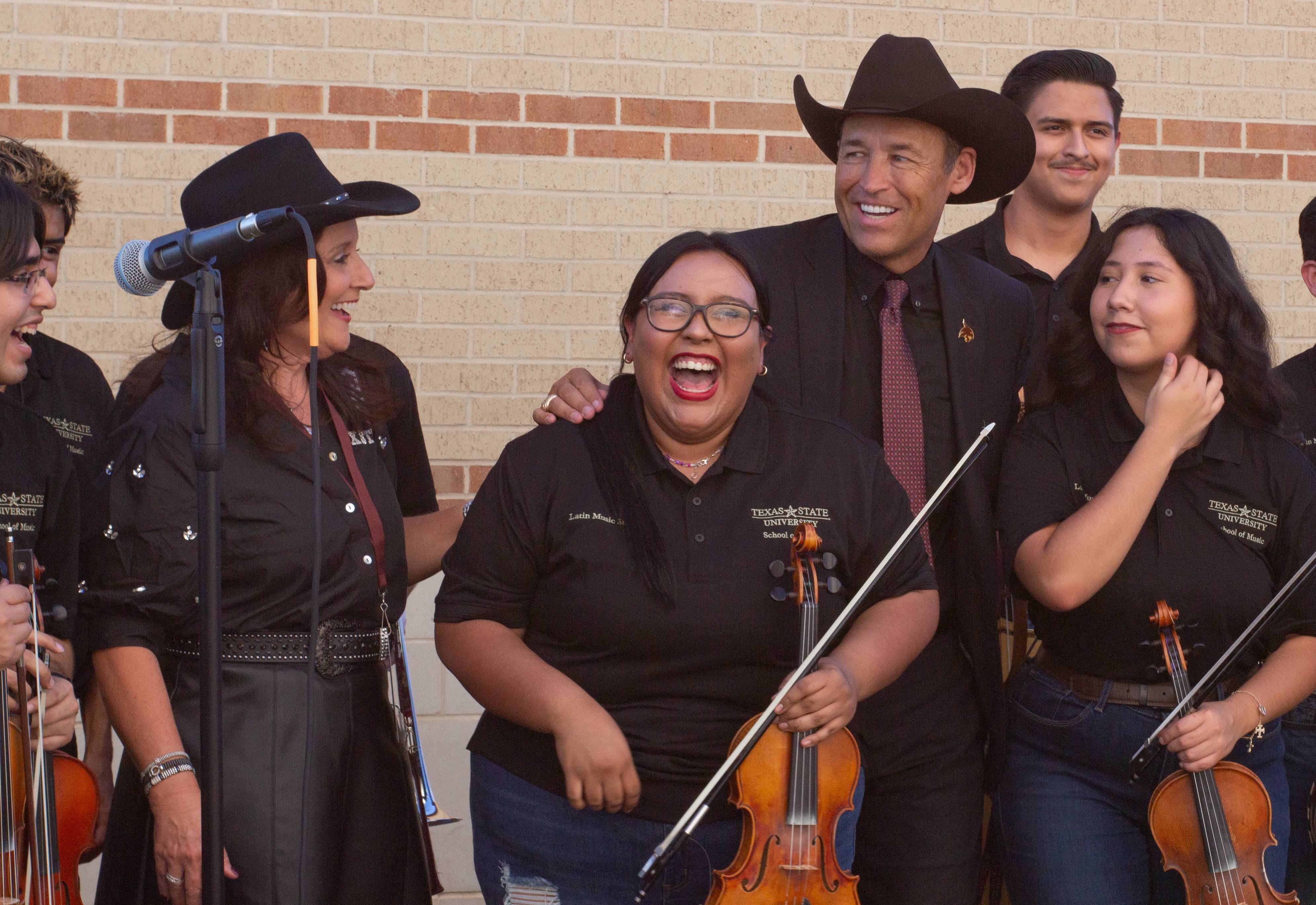 mariachi band members posing for a group photo