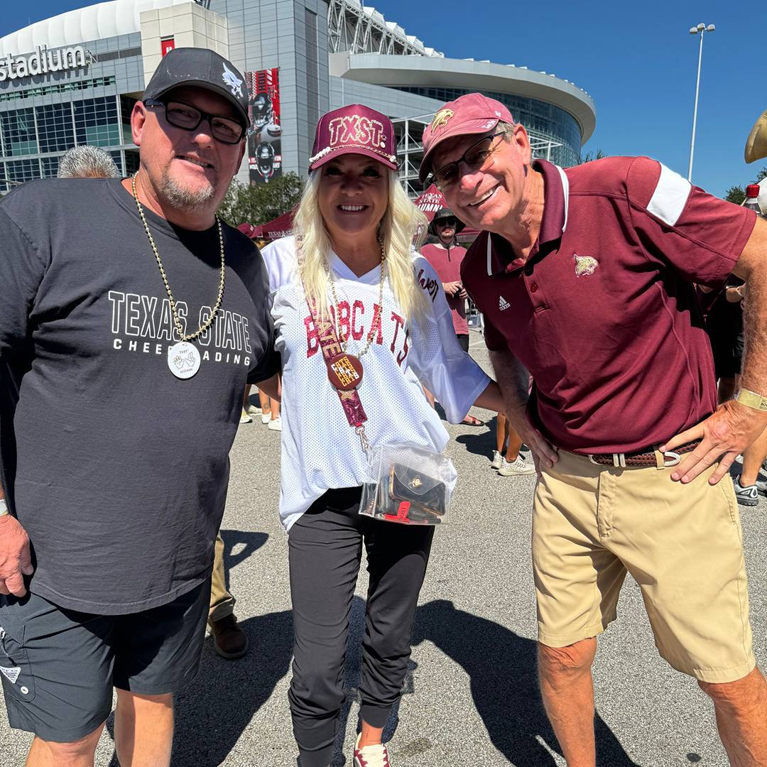 Three Texas State fans at the alumni tailgate in Houston