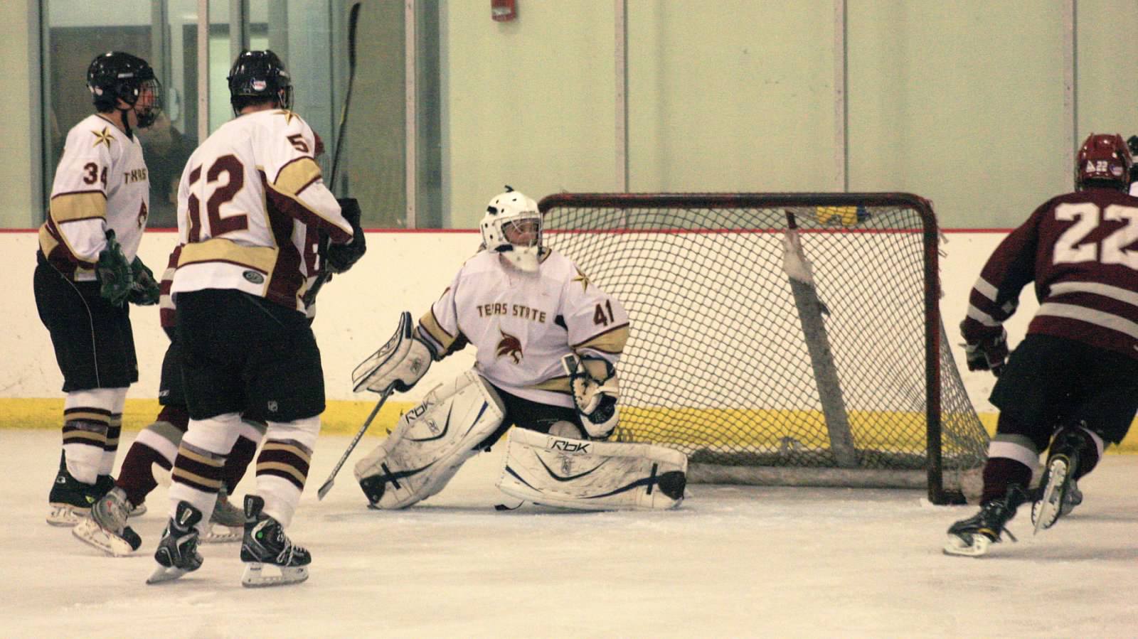 Ice hockey sport club goalie saving a puck from entering the goal