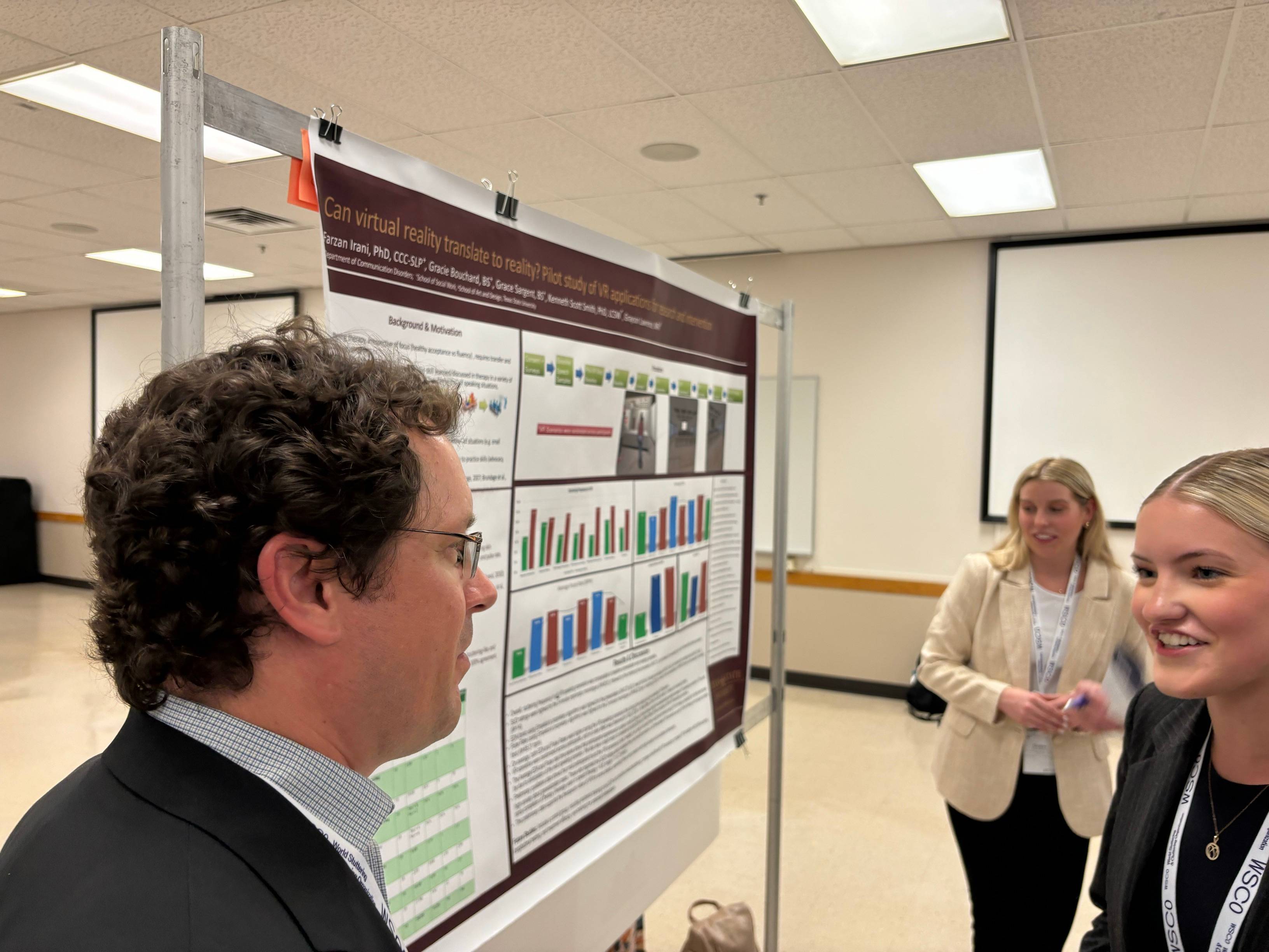 CDIS students explaining their poster.