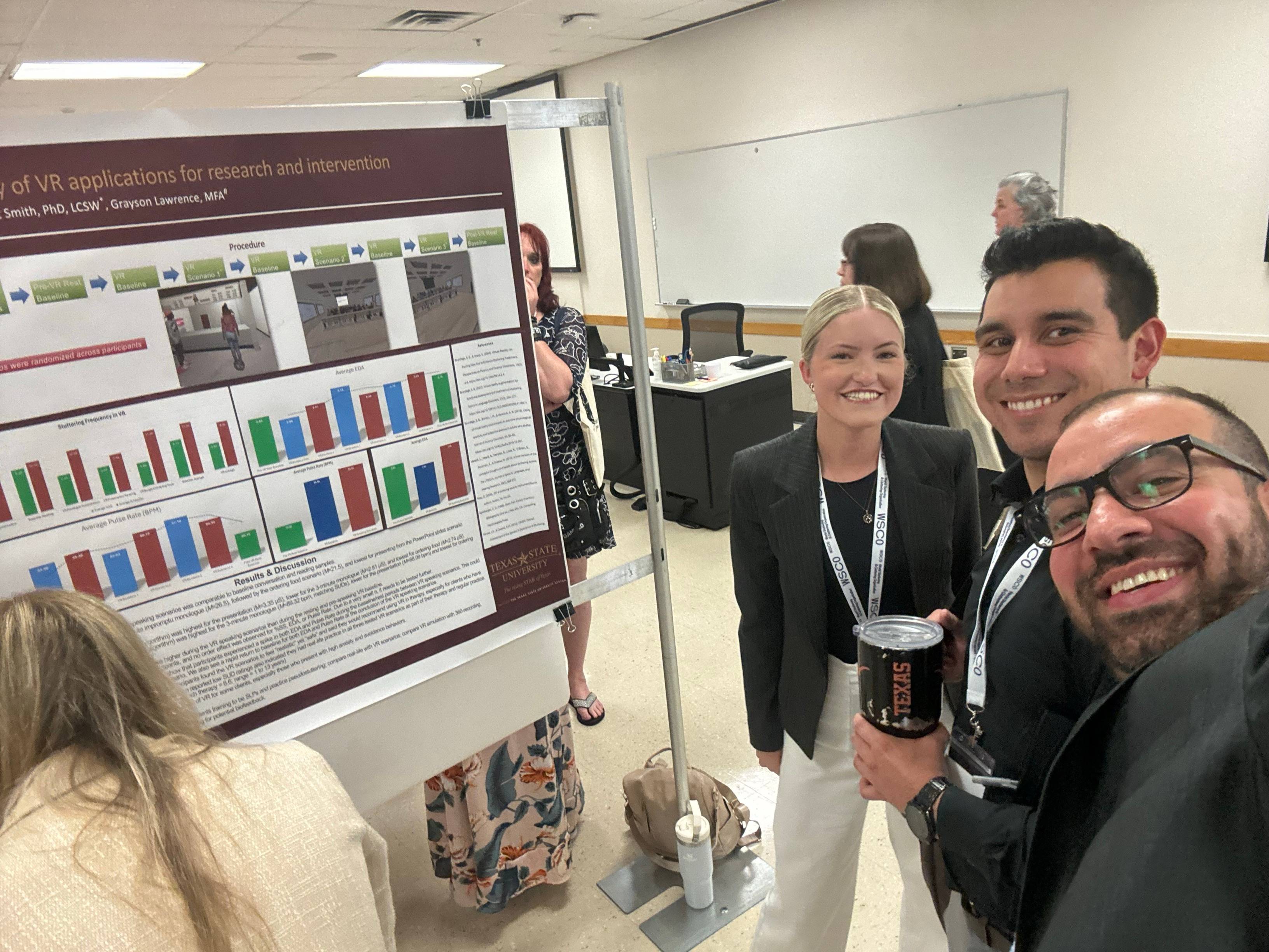 Dr. Irani and CDIS students presenting their poster.