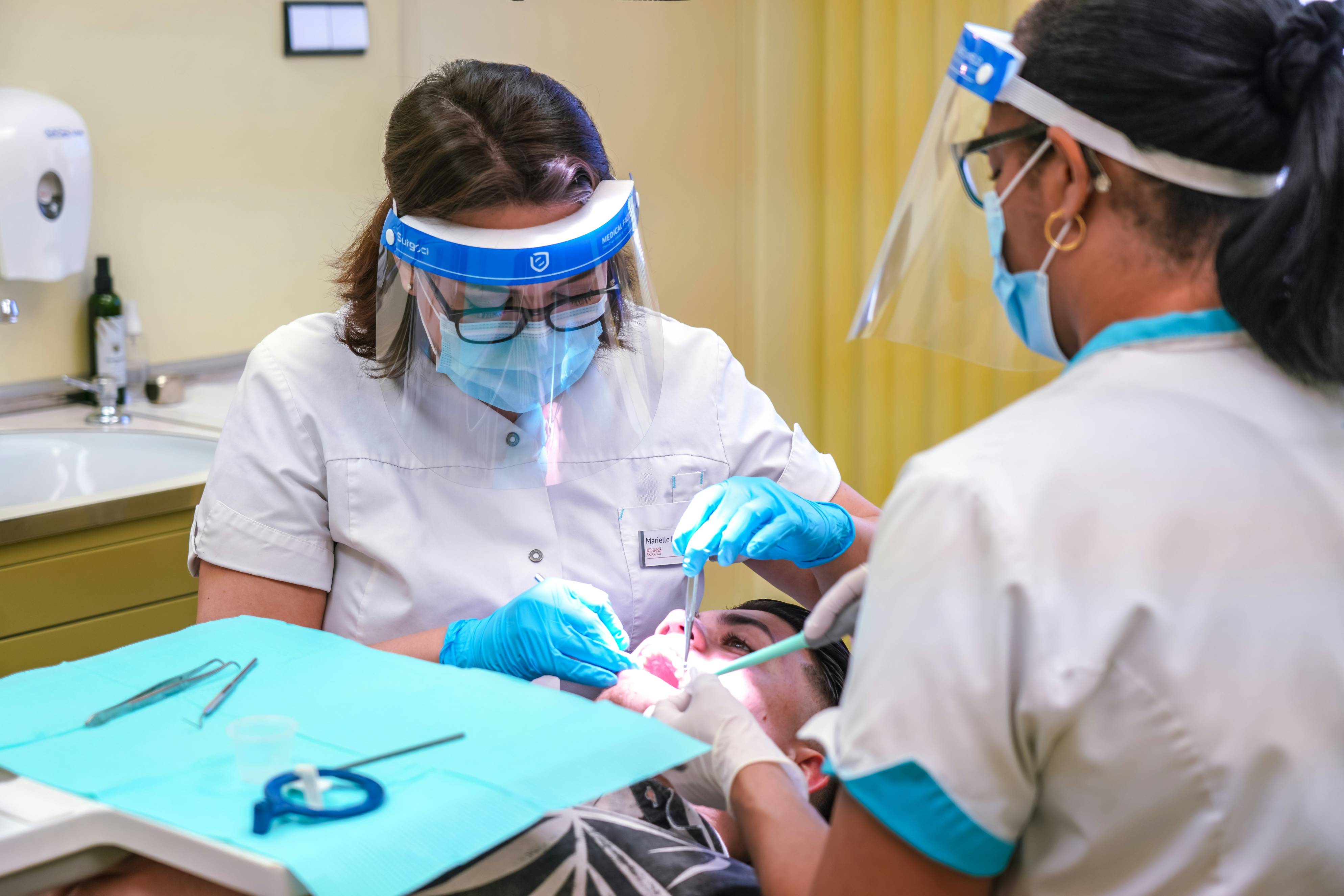 Dental Assistant working on student