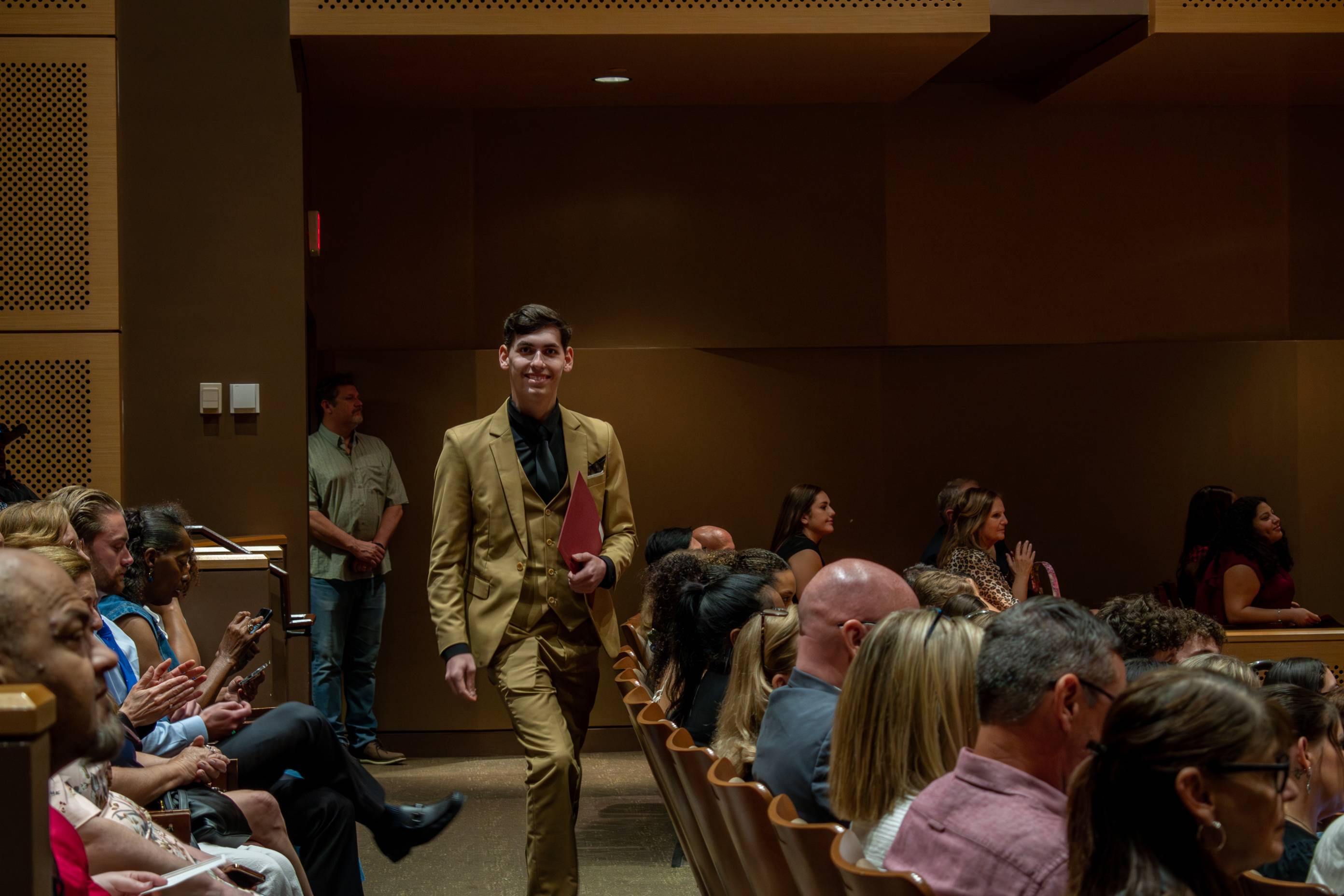 Thomas Clarke shaking hands with a Council of Scholars recipient.