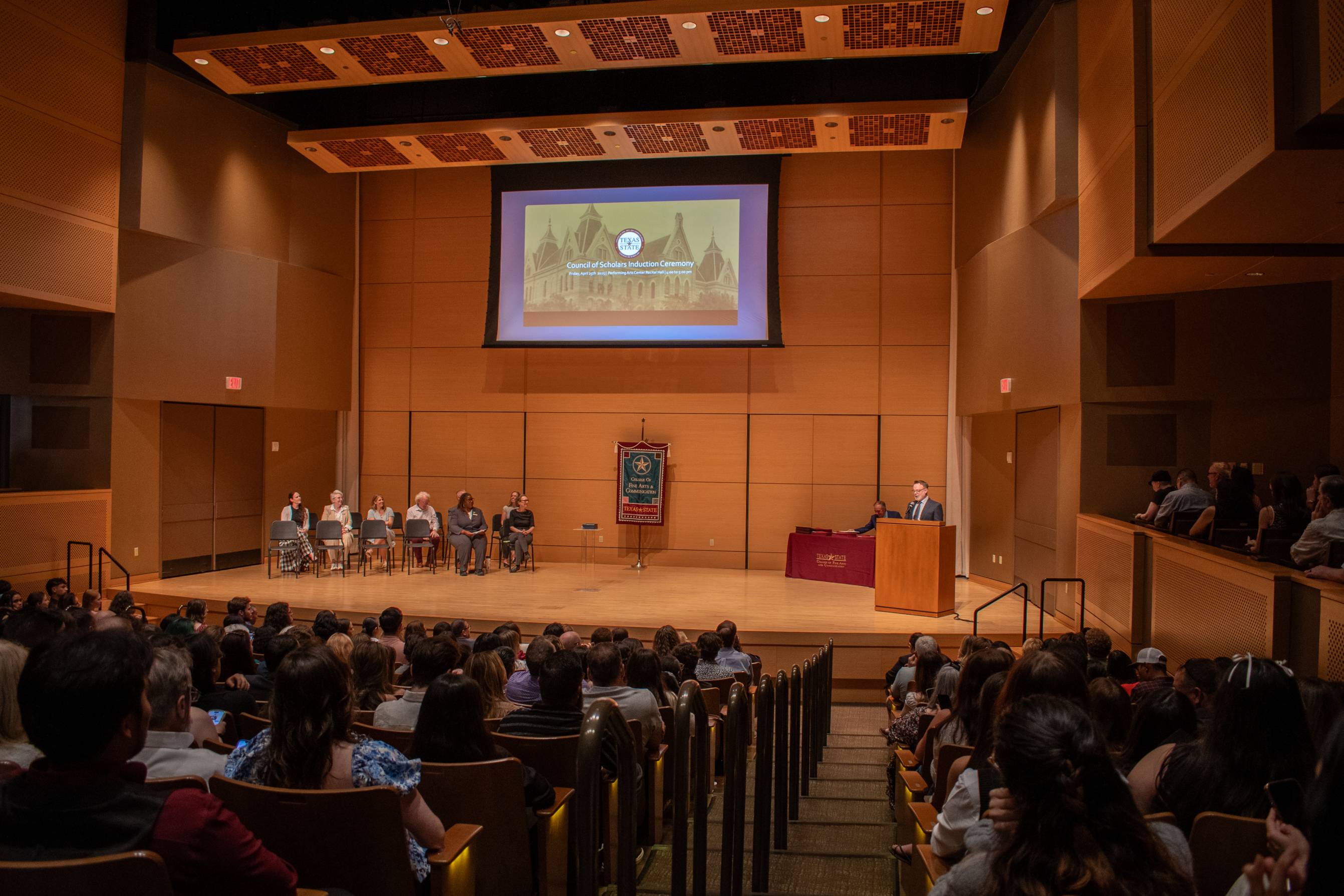guests gather in the performing arts center for the council of scholars ceremony 