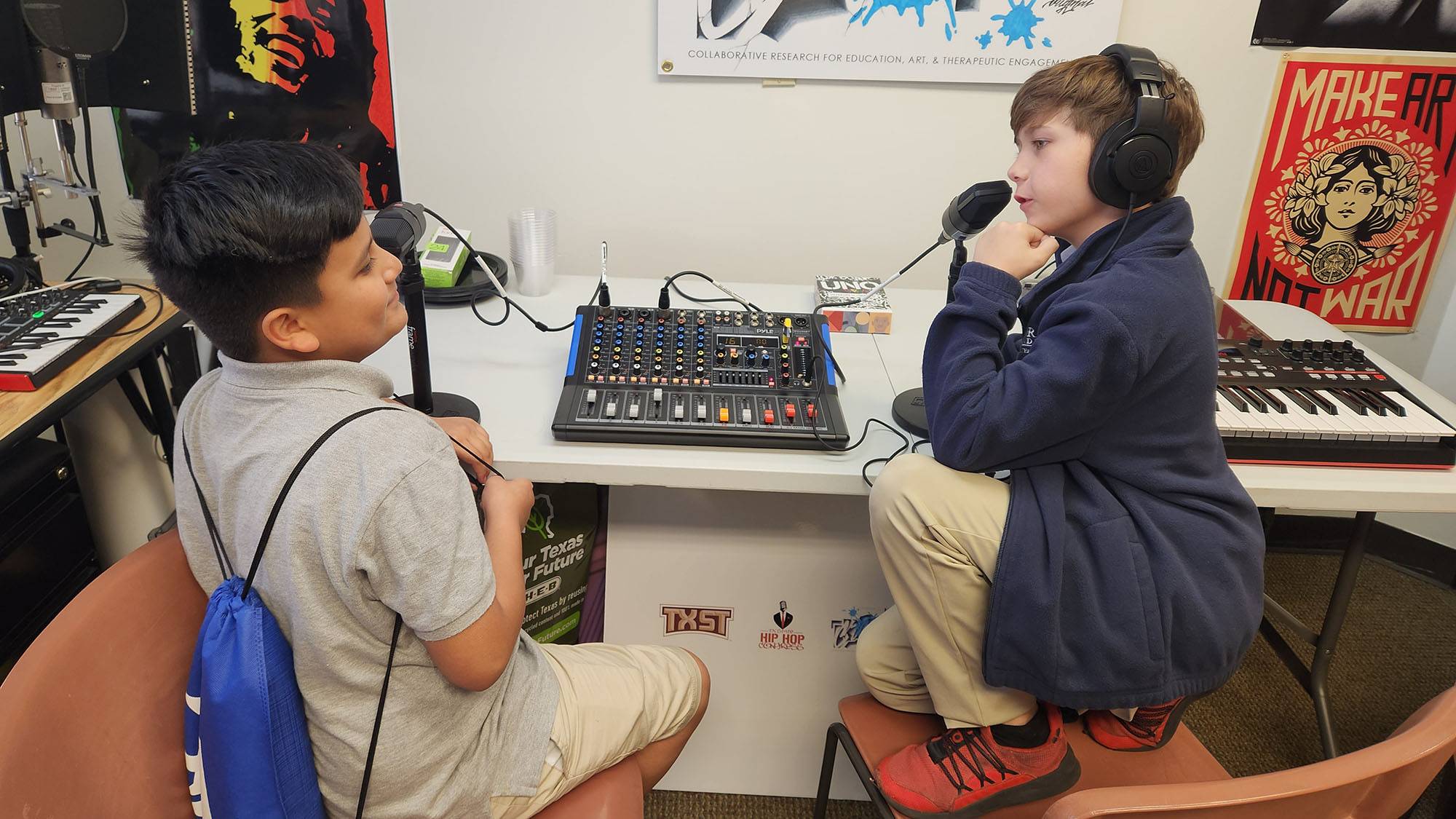 Elementary school students talk to each other using the sound board.