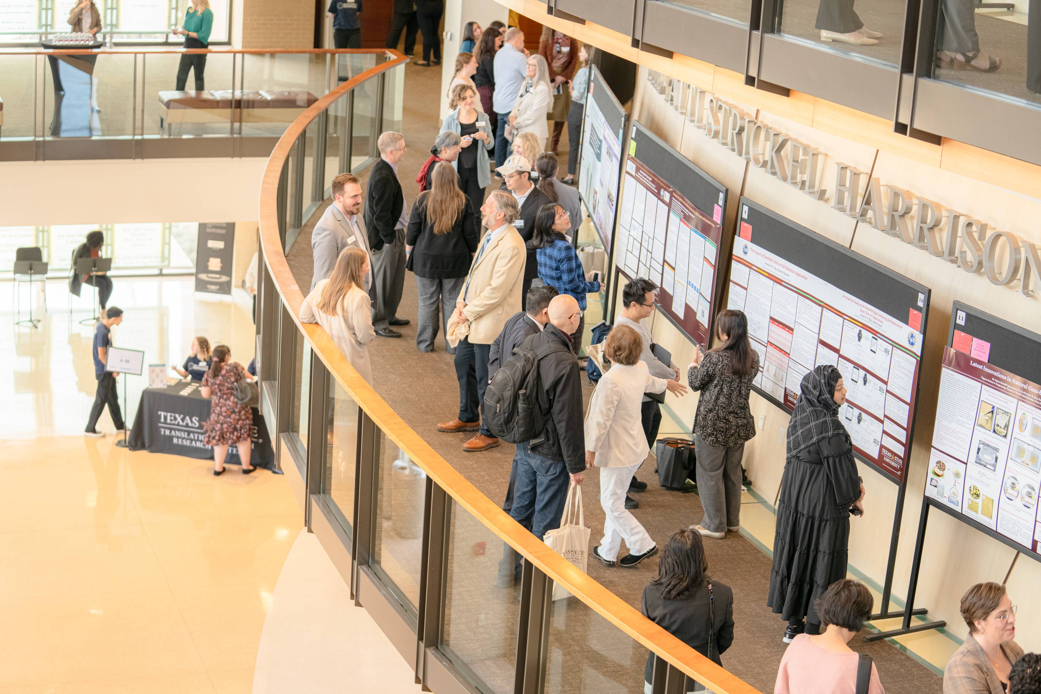 Faculty member standing in front of their research poster at the Health Scholar Showcase.