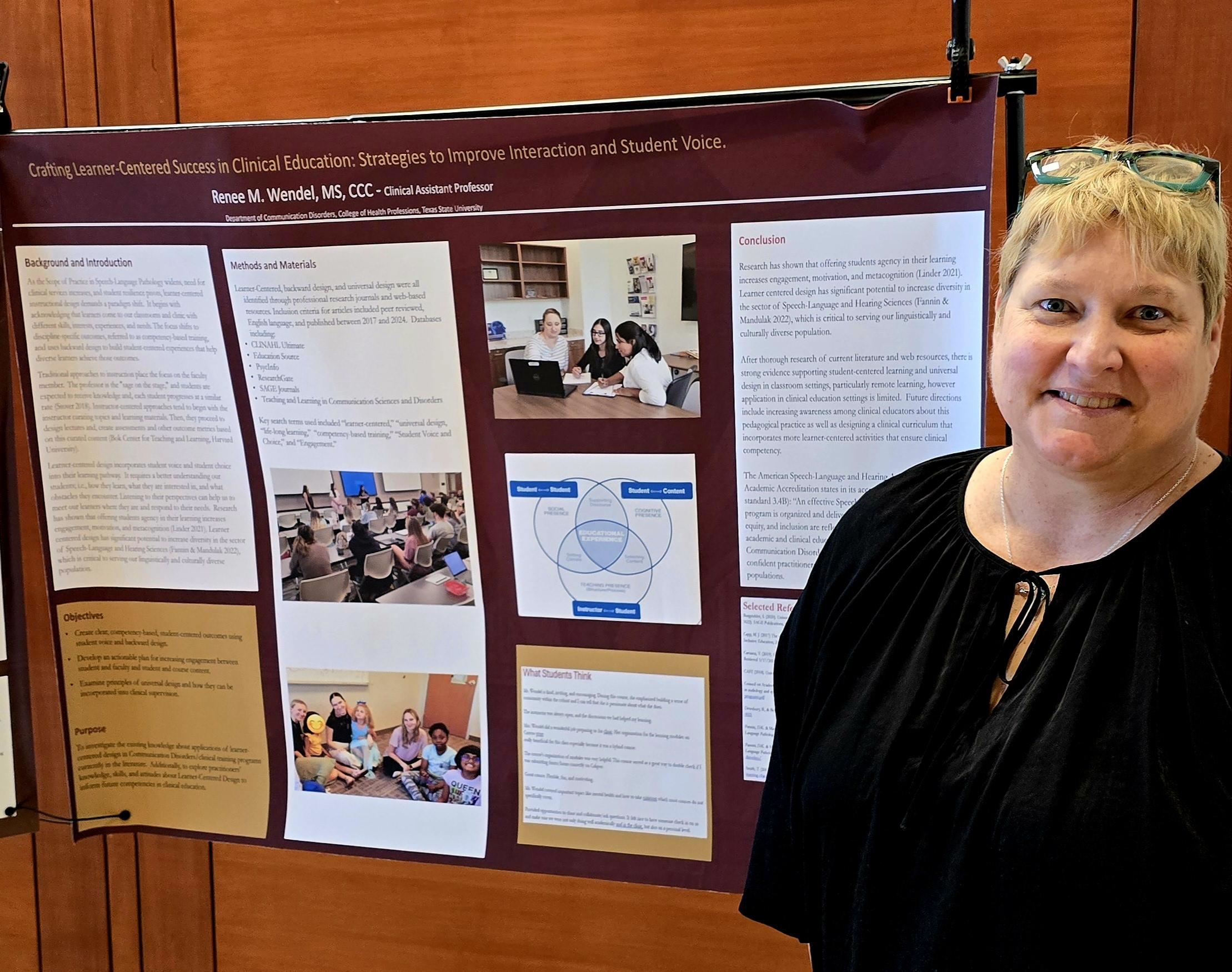 Ms. Rene Wendel standing next to her research faculty.