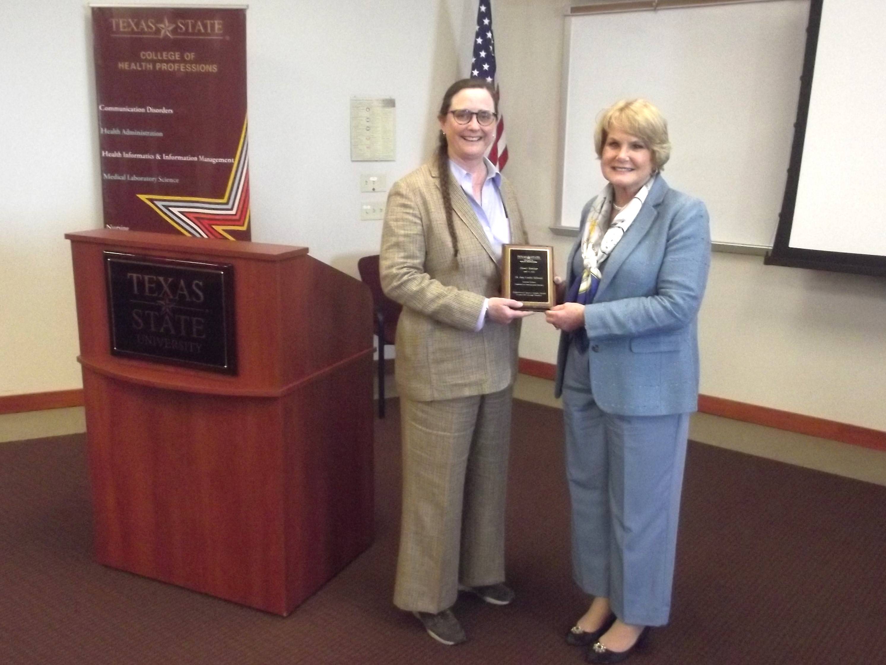 Dr. Schwarz receiving a plaque during the Dean's Seminar.