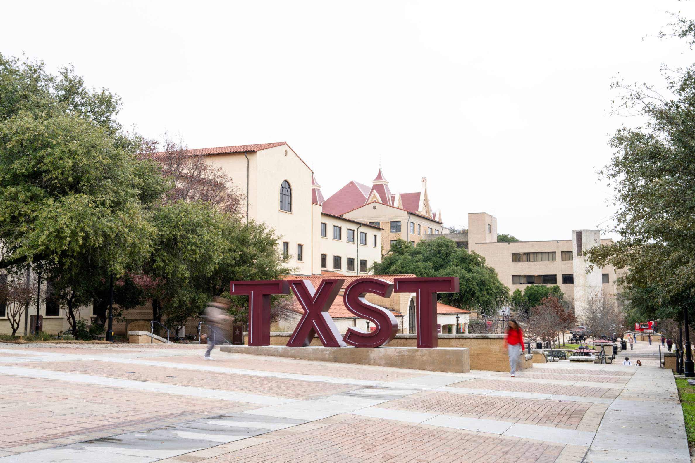 TXST letters next to flowers hall