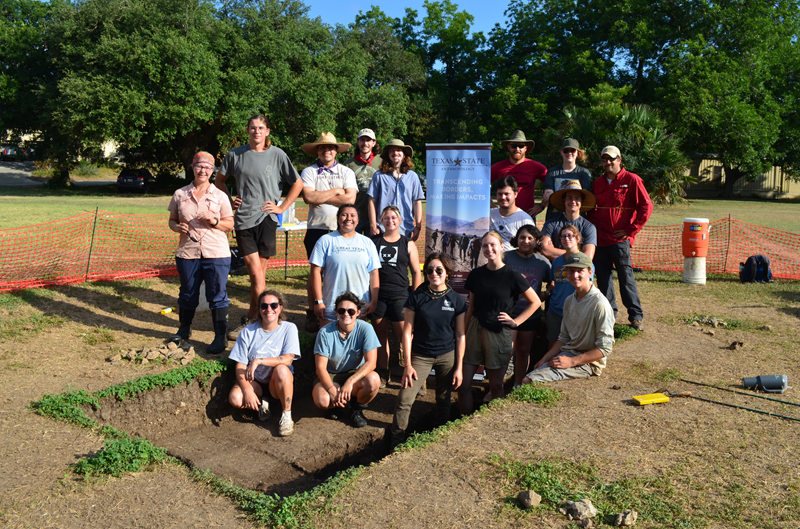 Students in archaeological field school pose for a picture