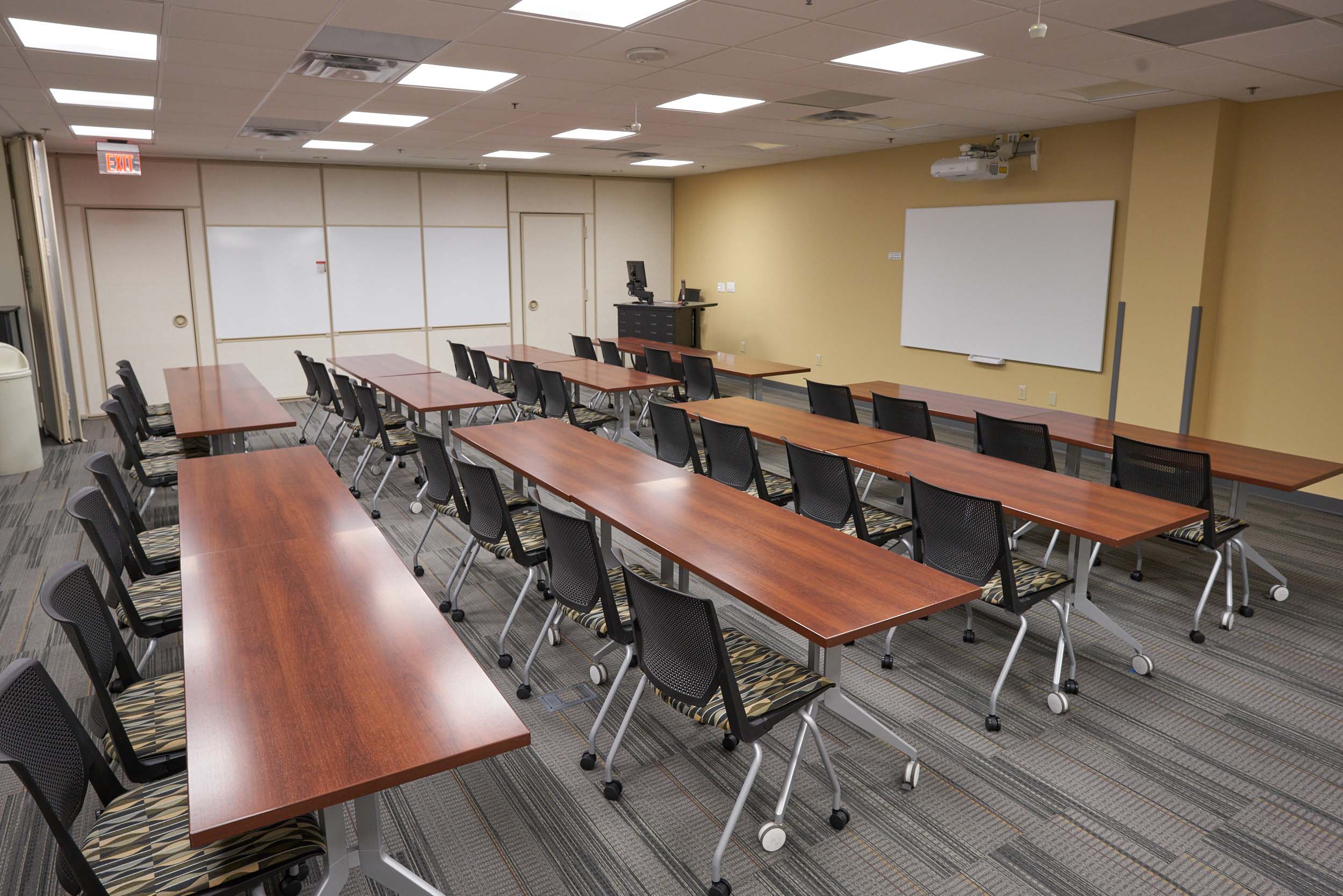 conference hall with chairs, tables and white boards