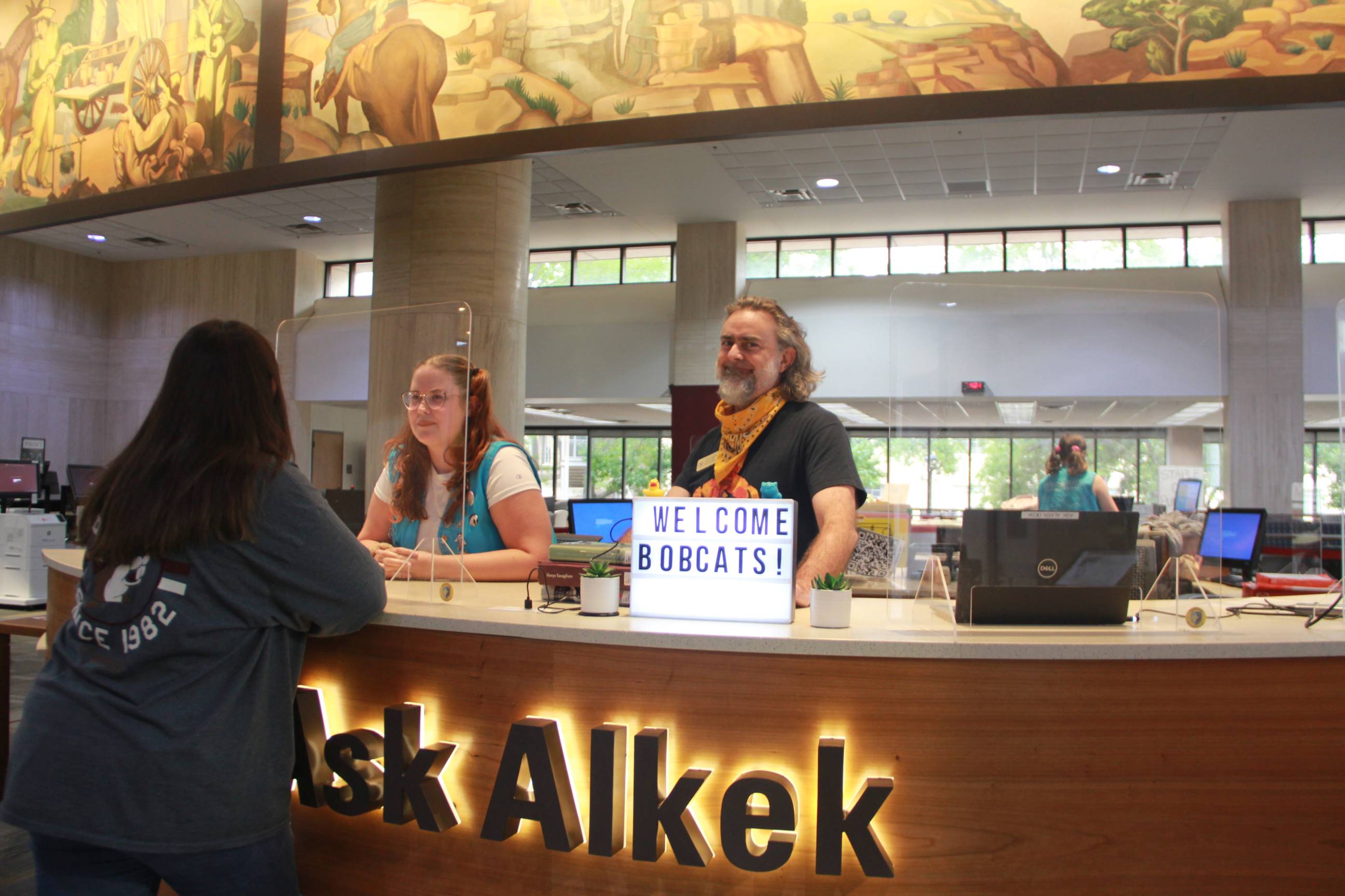 photo of two people at Ask Alkek desk