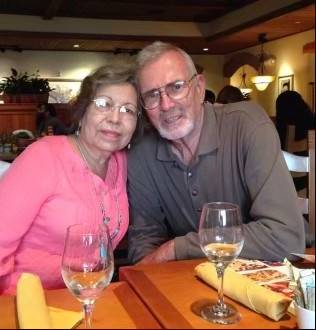 a group photo of people standing in front of a statue