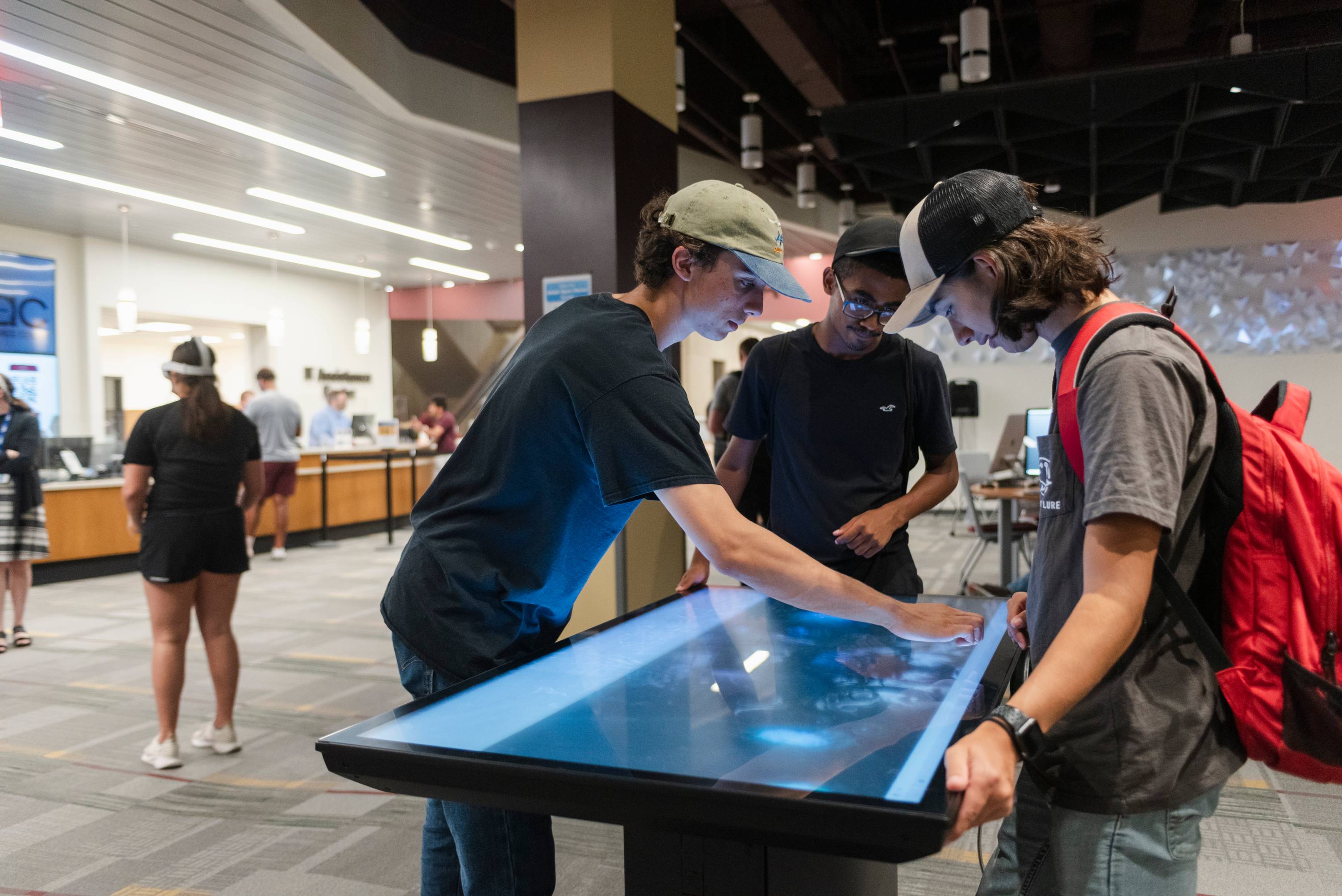 Students interacting with a touch screen table