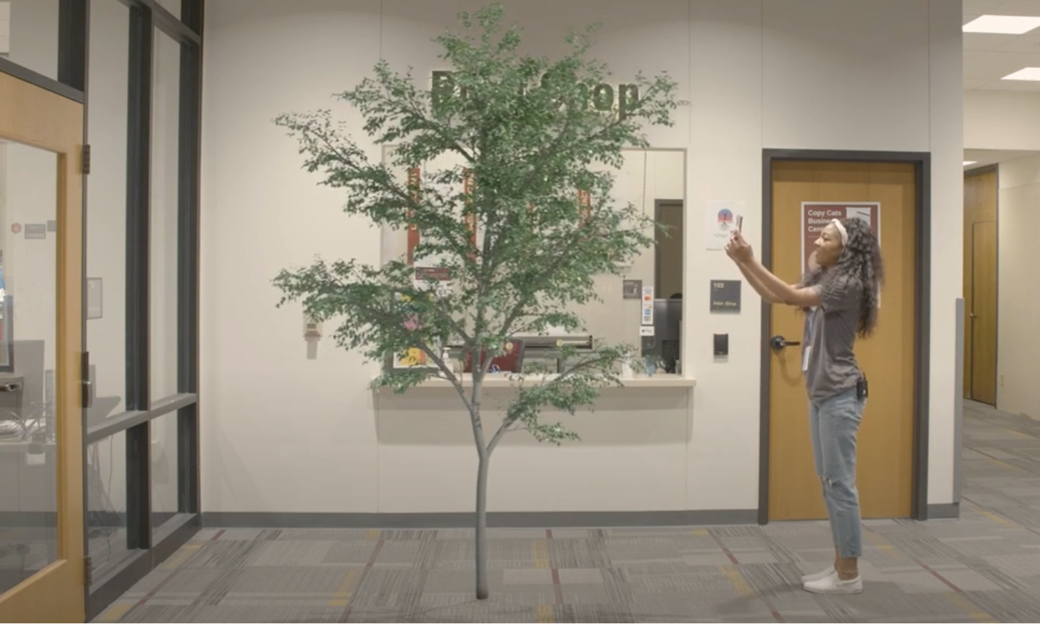 Image of girl interacting with a 3D augmented tree