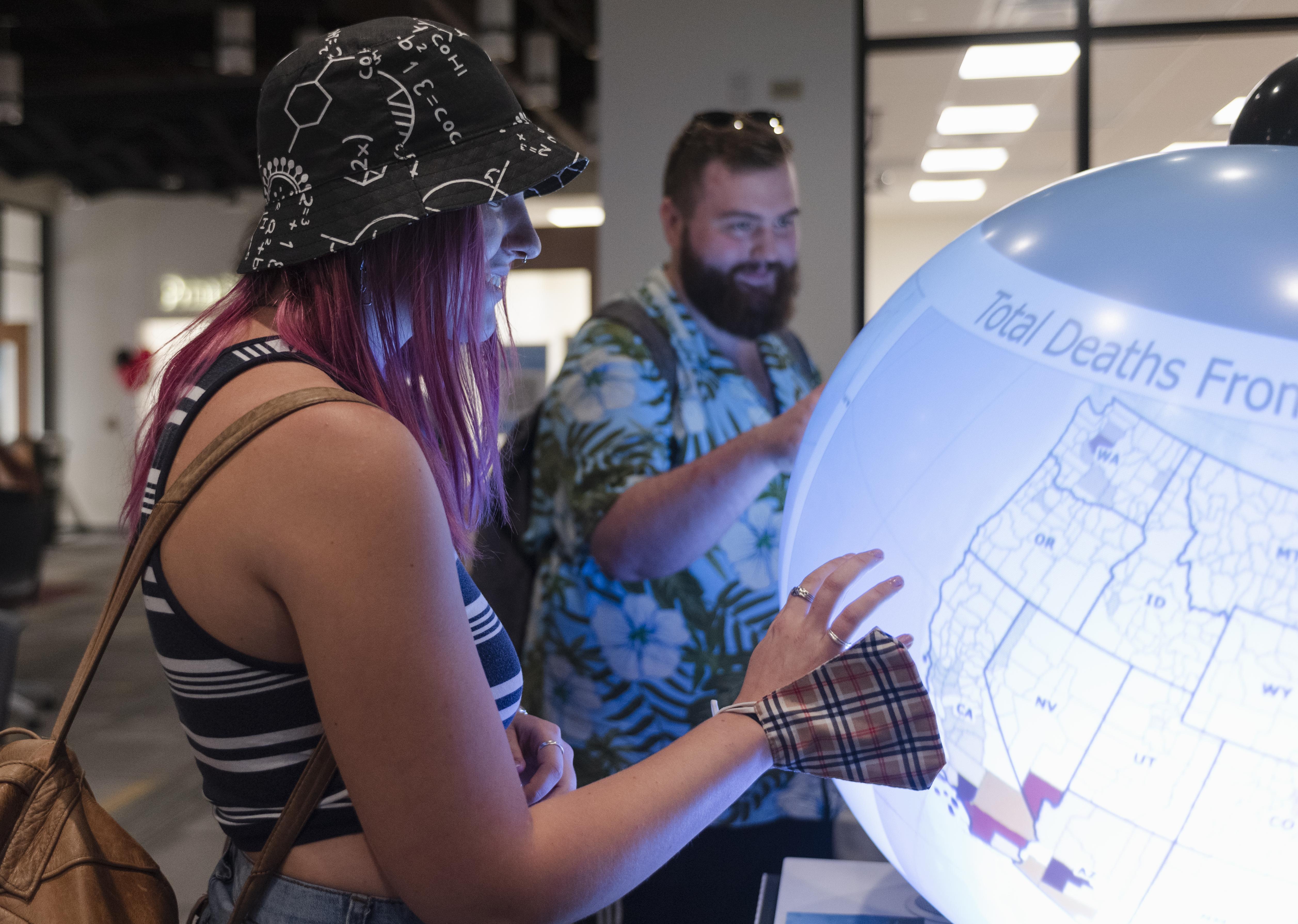 people interacting with a globe