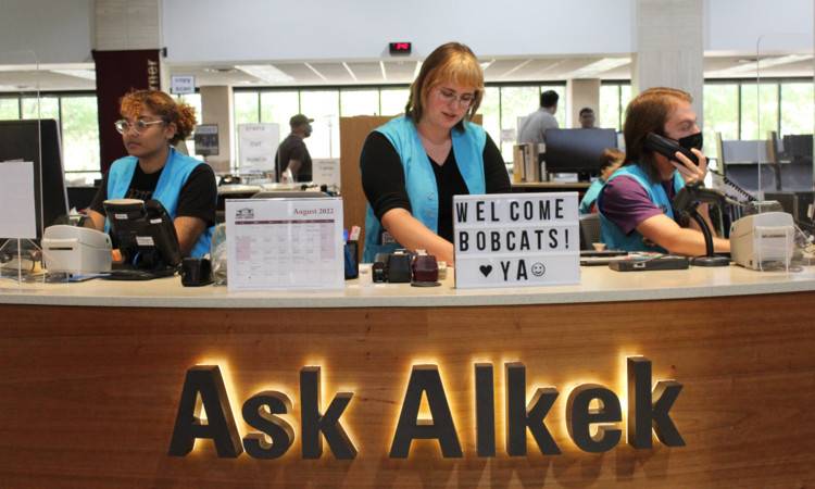 Employees assisting patrons at the desk