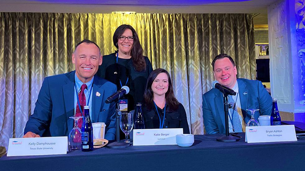 President Kelly Damphousse (left) sits next to Elizabeth Béjar, Katie Berger, and Bryan Ashton for a photo on stage..