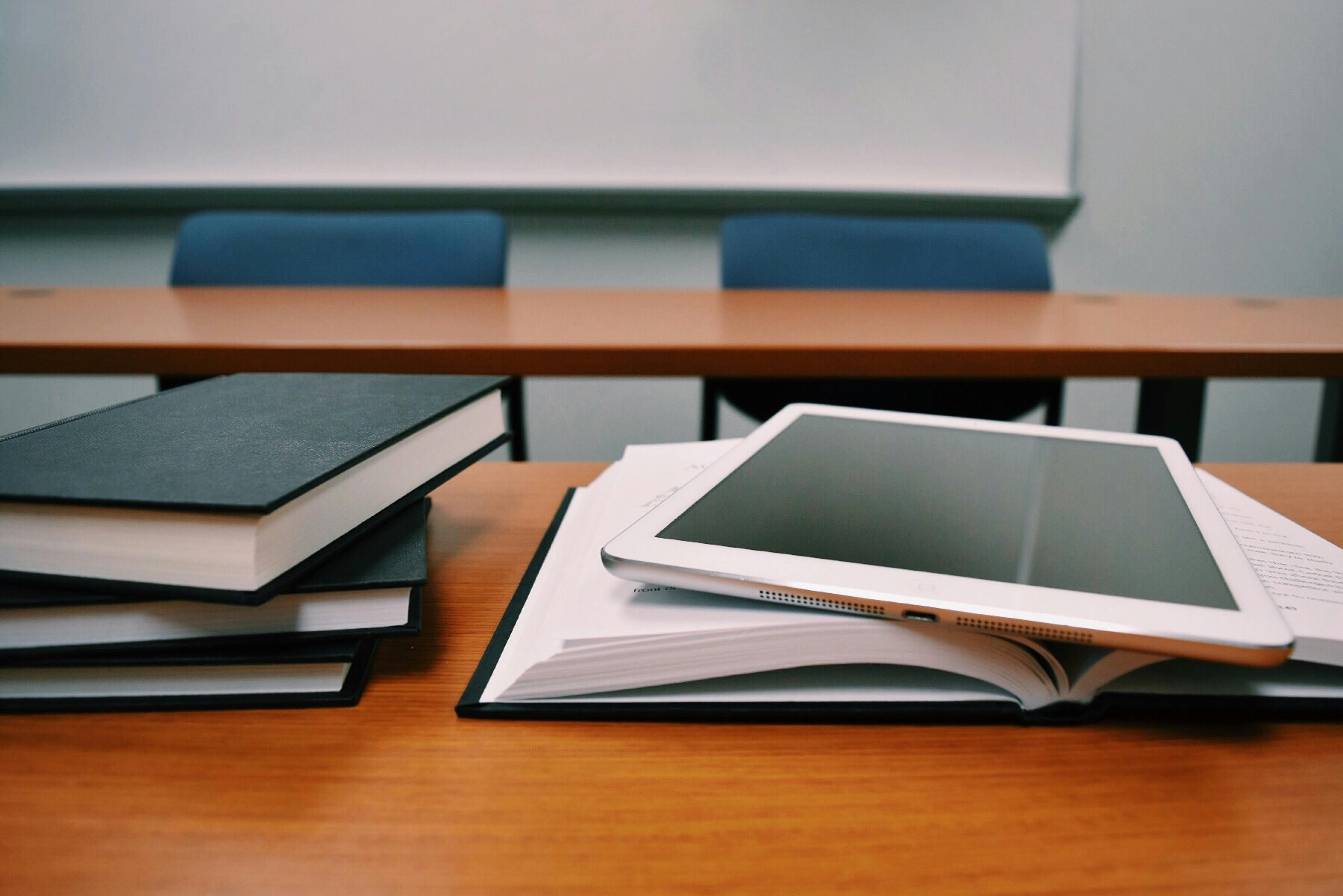 Image of books on a desk and ipad