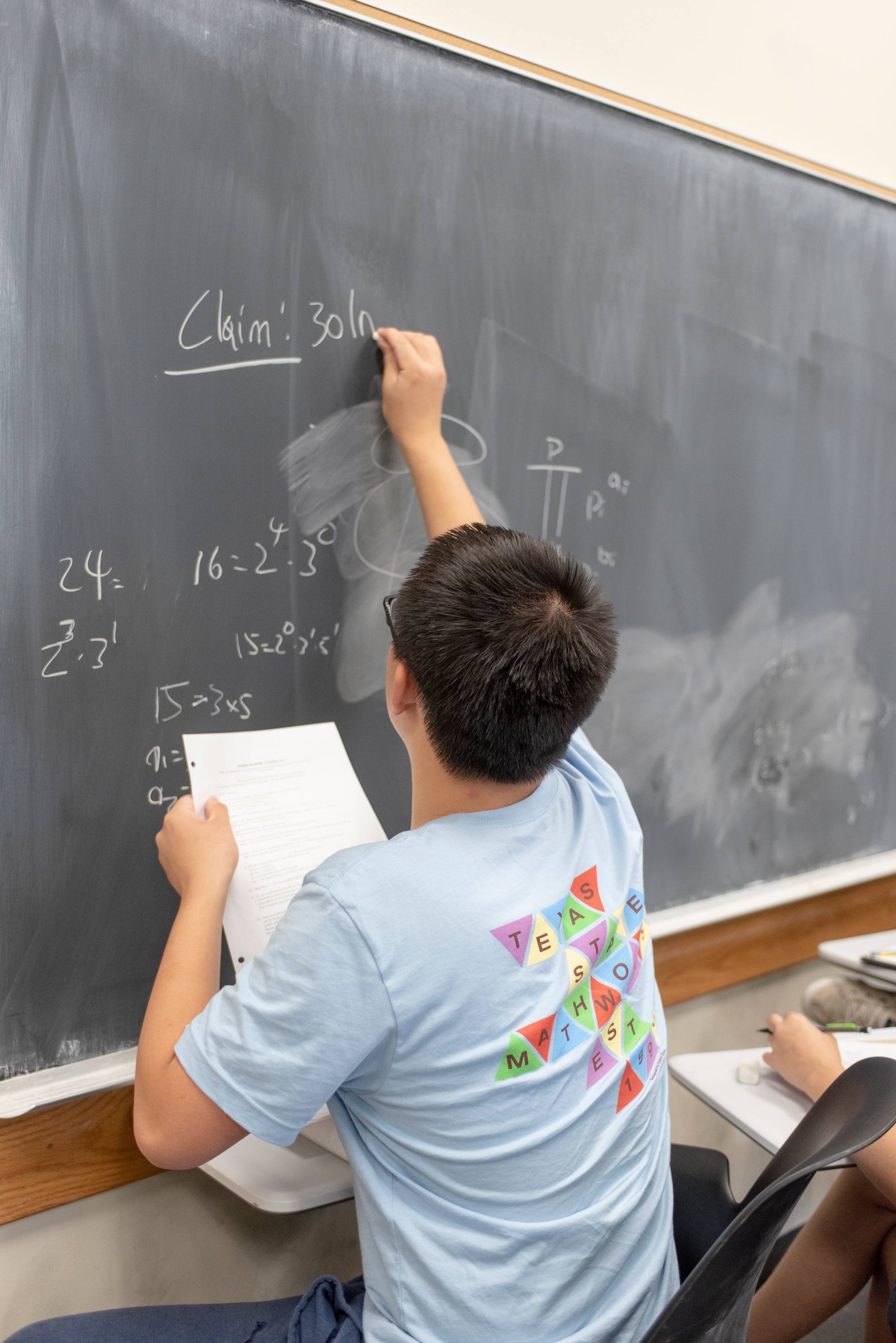 HSMC student doing math at board