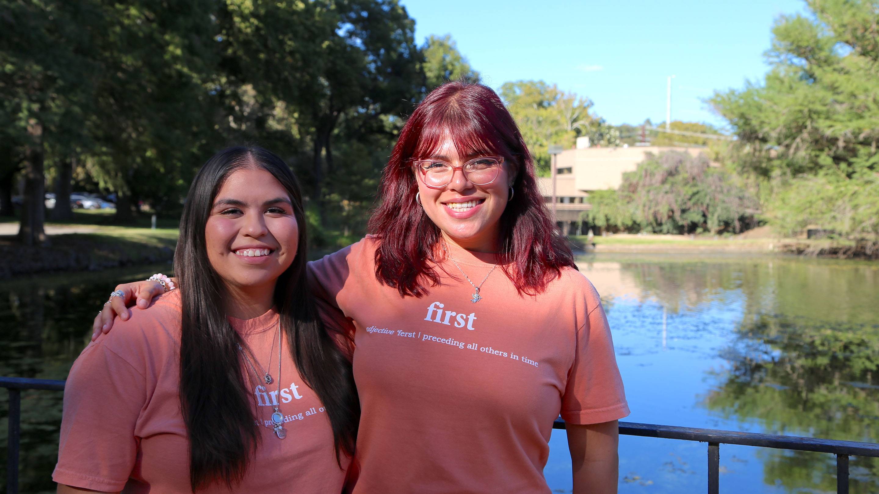 Kyrsten Perez and Jimena Rodriguez-Gamez pose for a picture together in front of the JCK ponds.