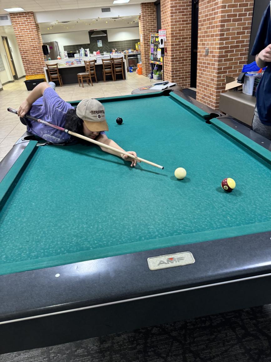Students playing pool in the dorm lobby