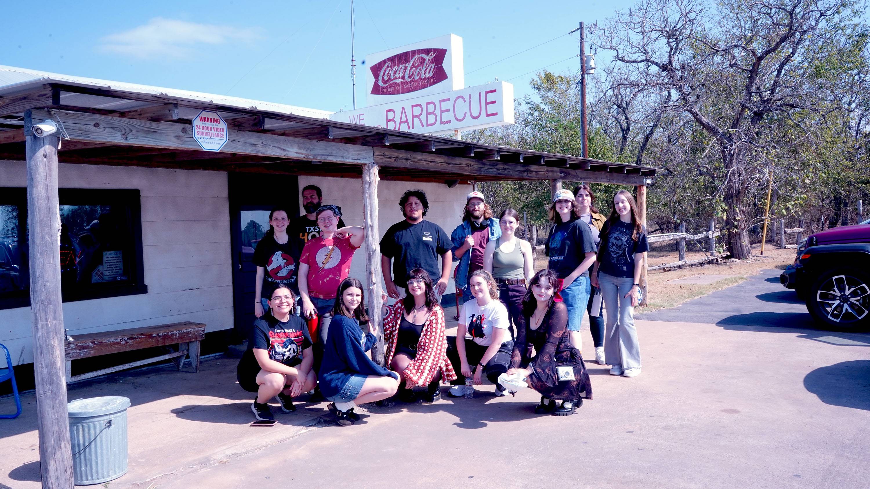 A group of students pose for a photo in front of The Gas Station.