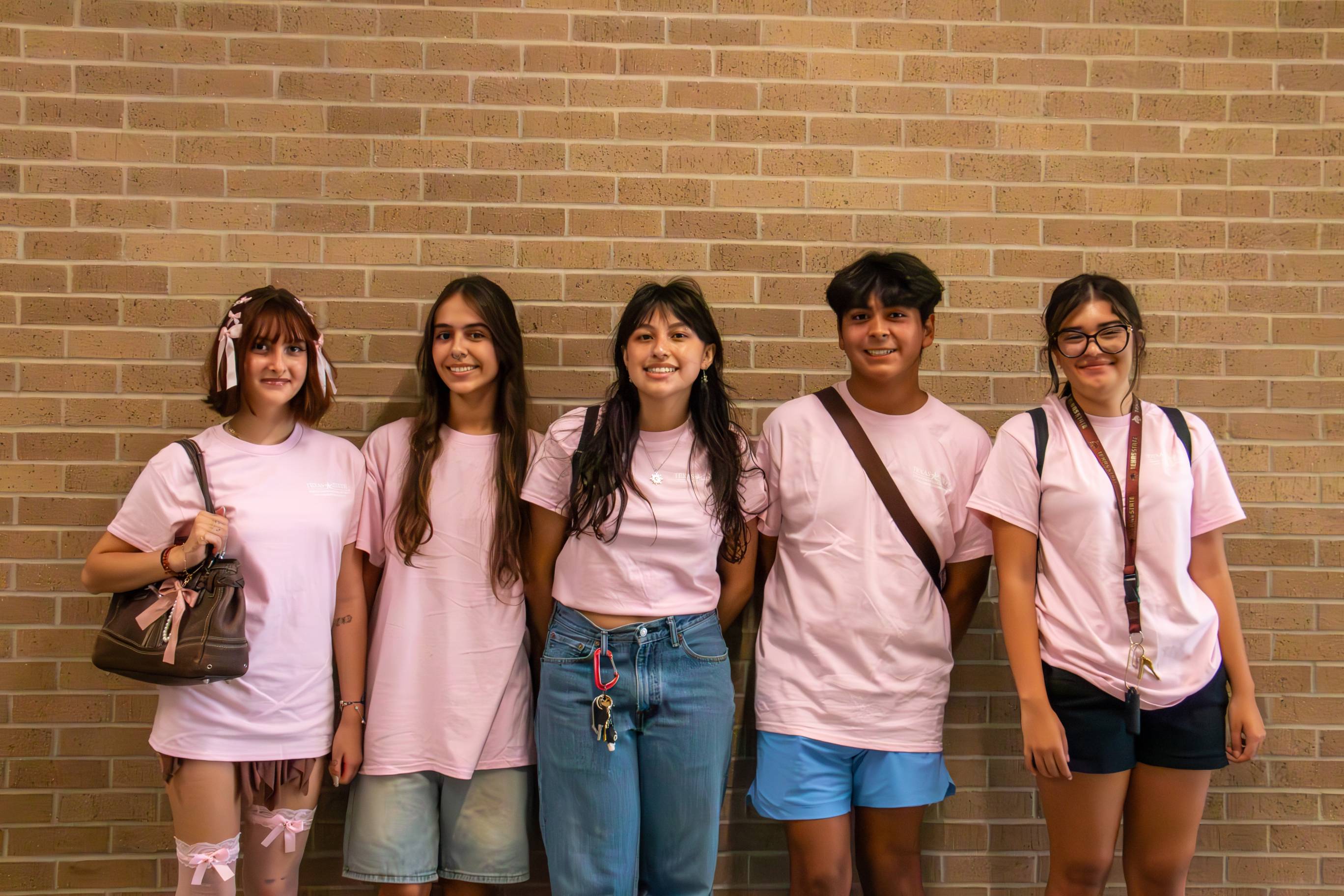 Five students in pink LLC shirts