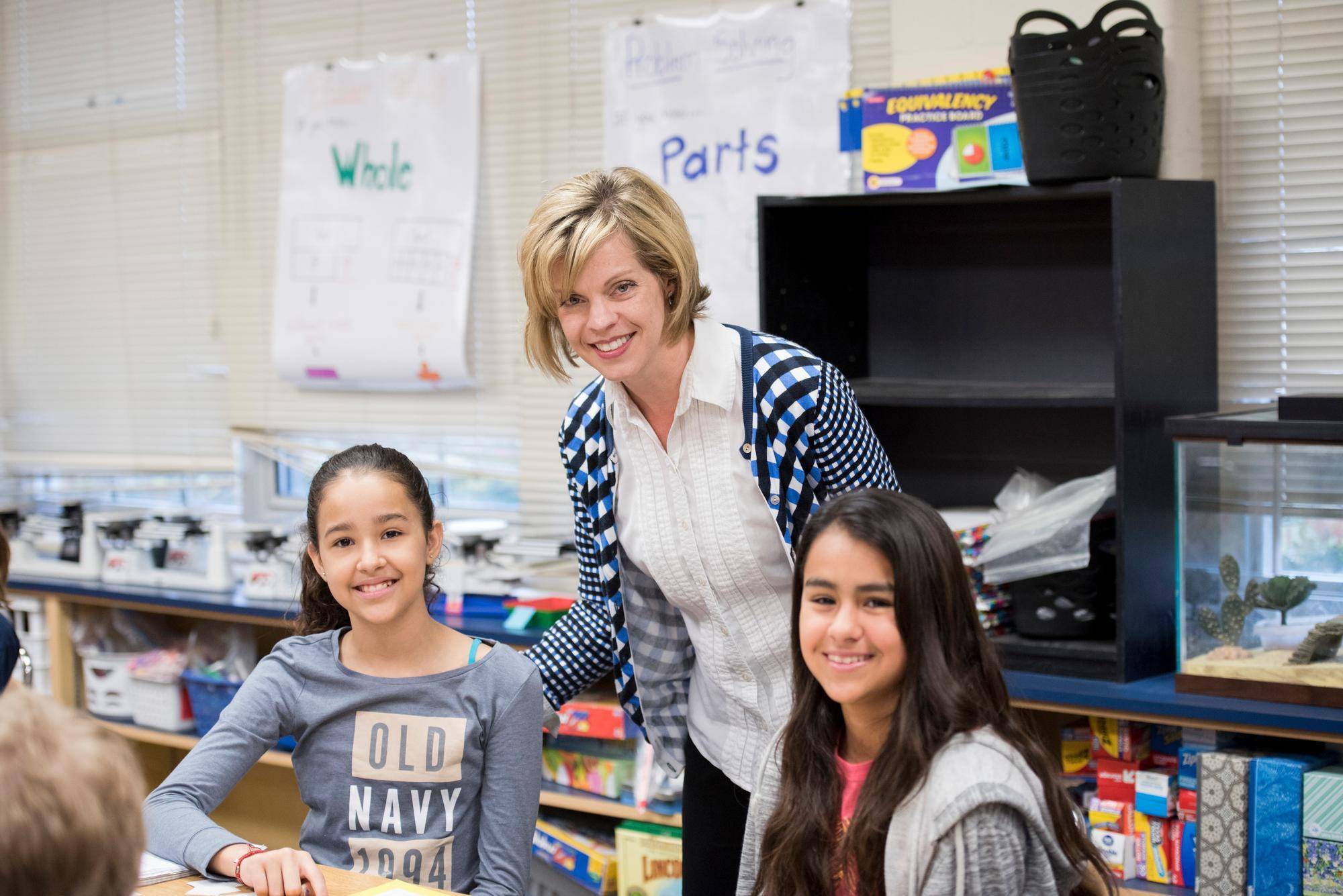 a teacher helping young students
