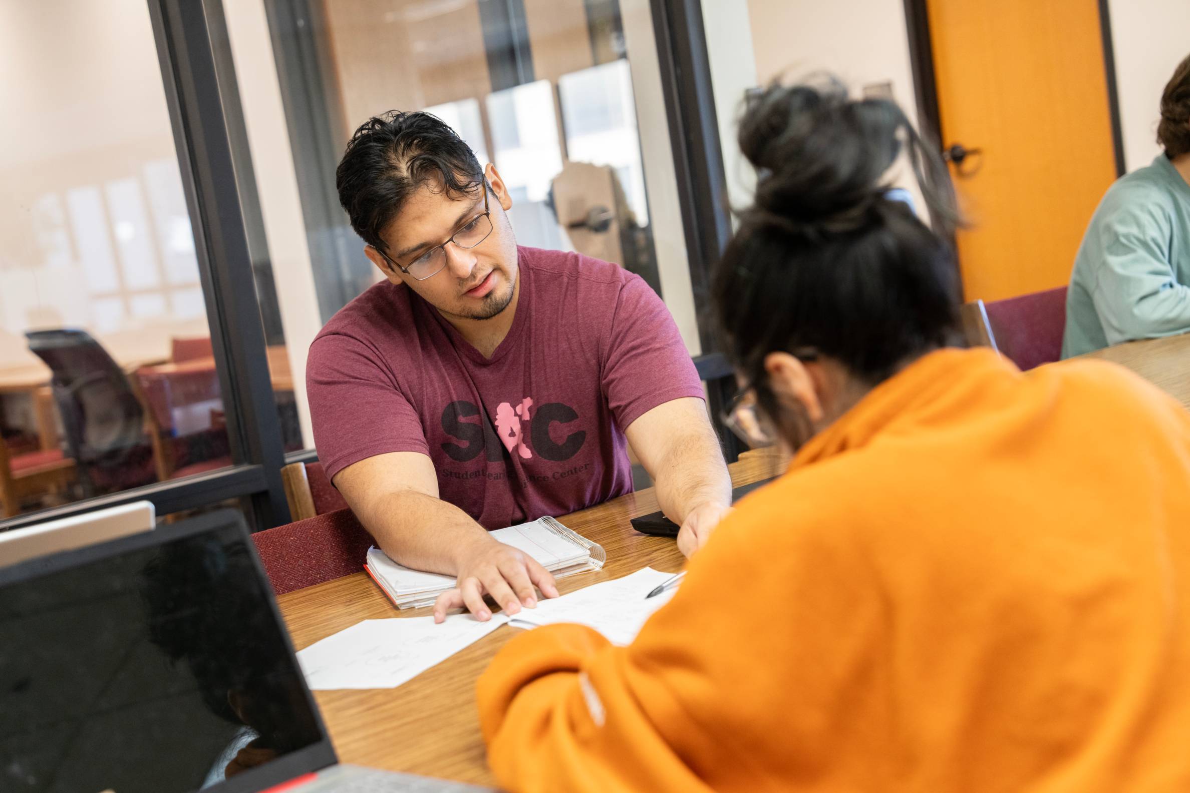 student helping another student with an assignment