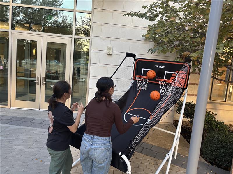 Students playing basketball in the courtyard of the Willow Hall building