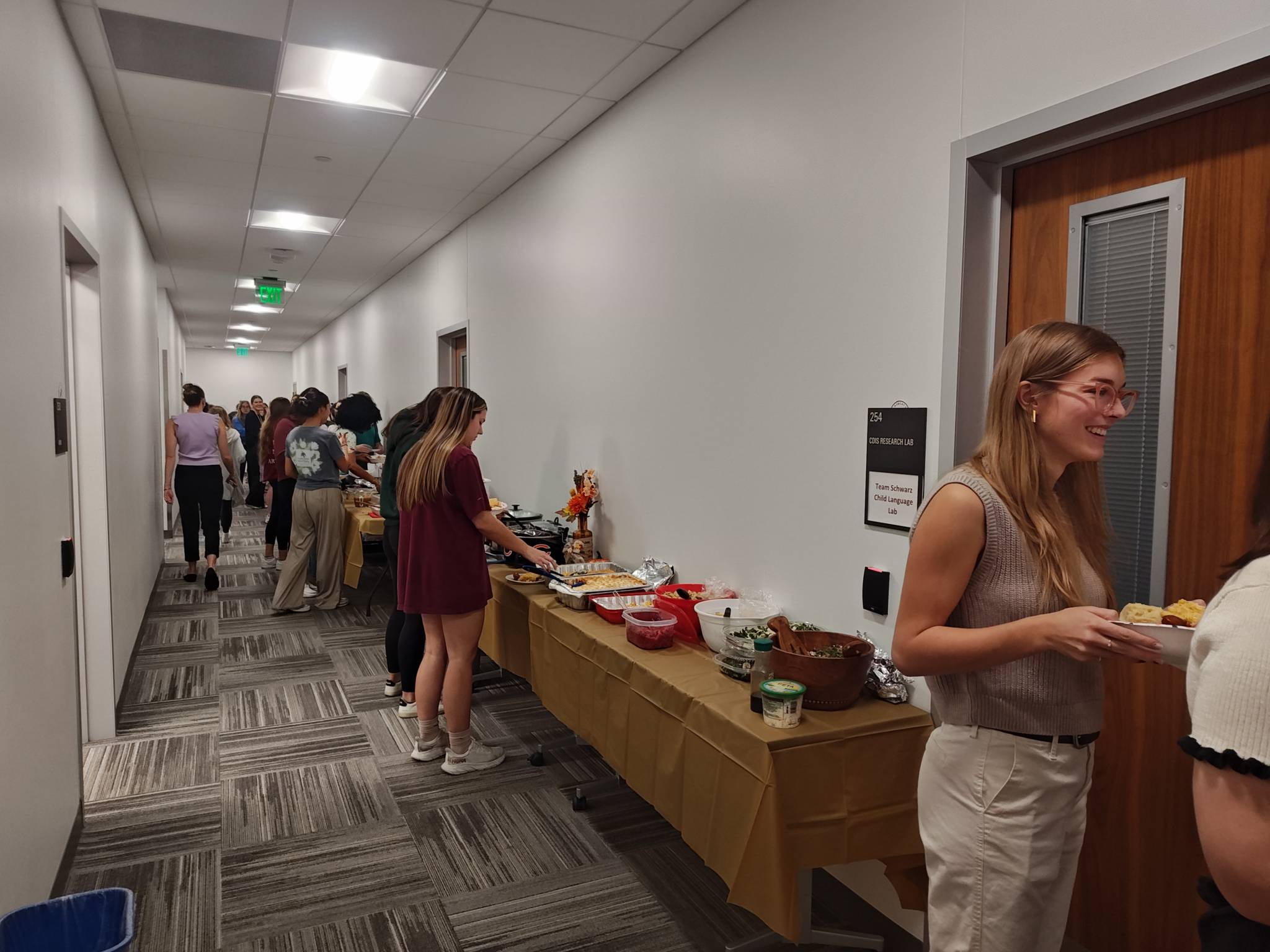 Students in line serving  their own food.