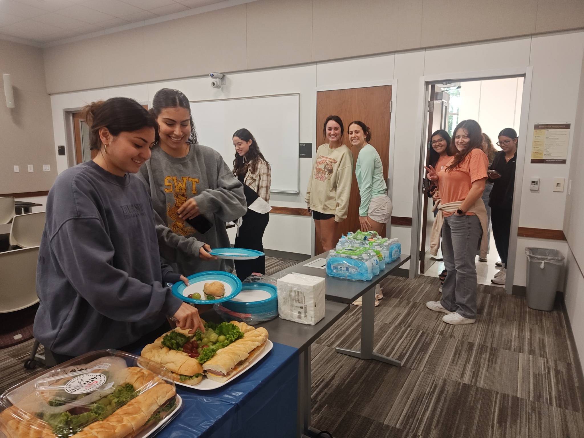 CDIS students in line to grab food.