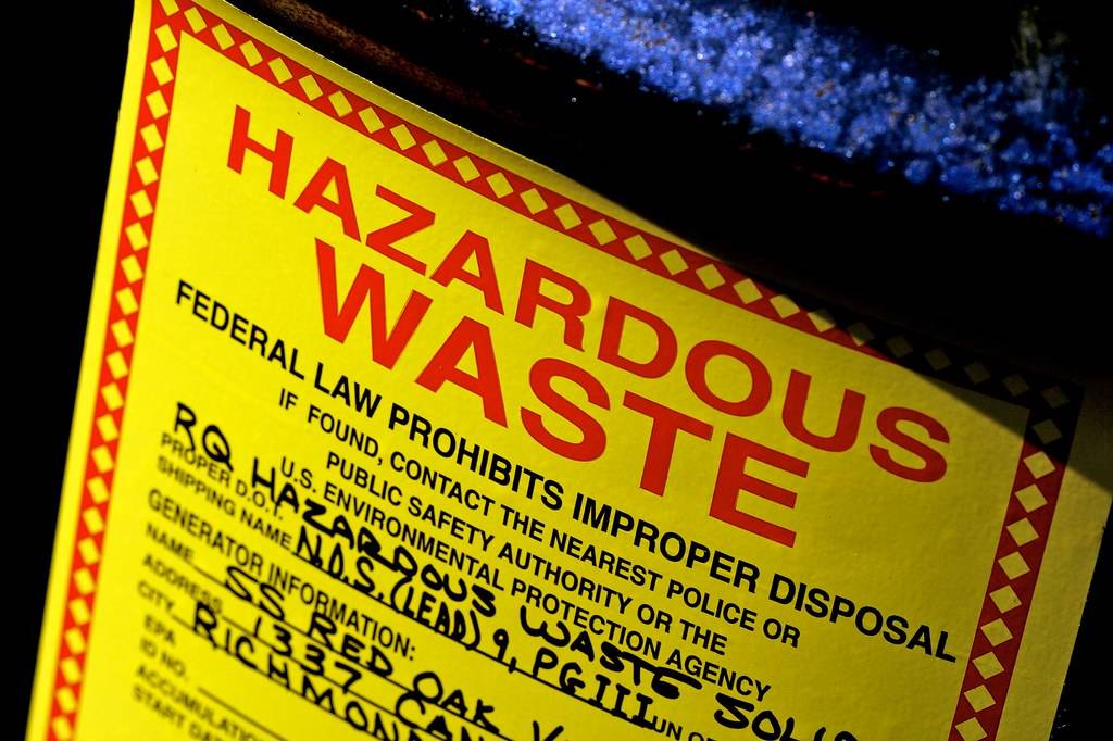 A yellow label on a hazardous waste drum