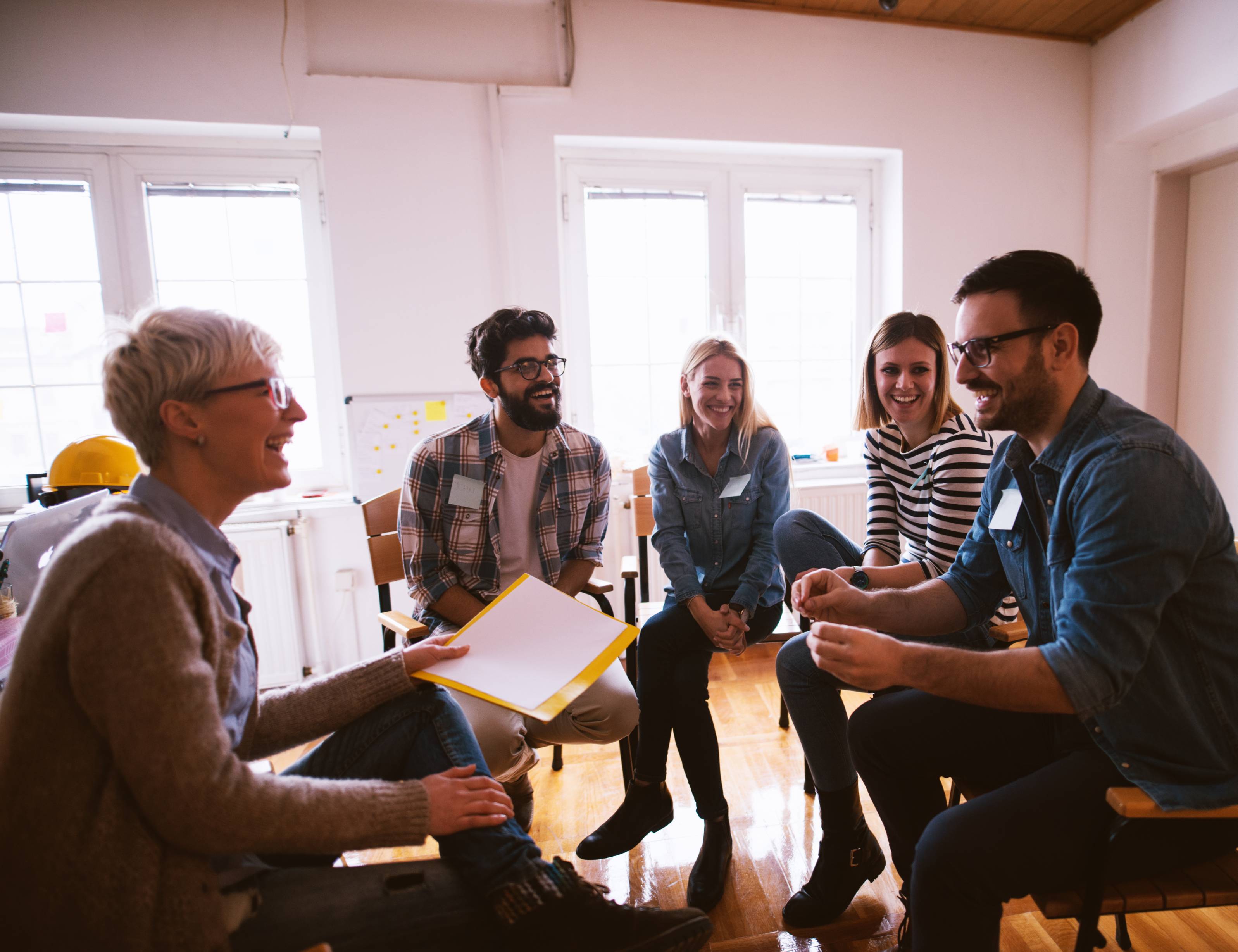 Social worker with other people in a meeting room