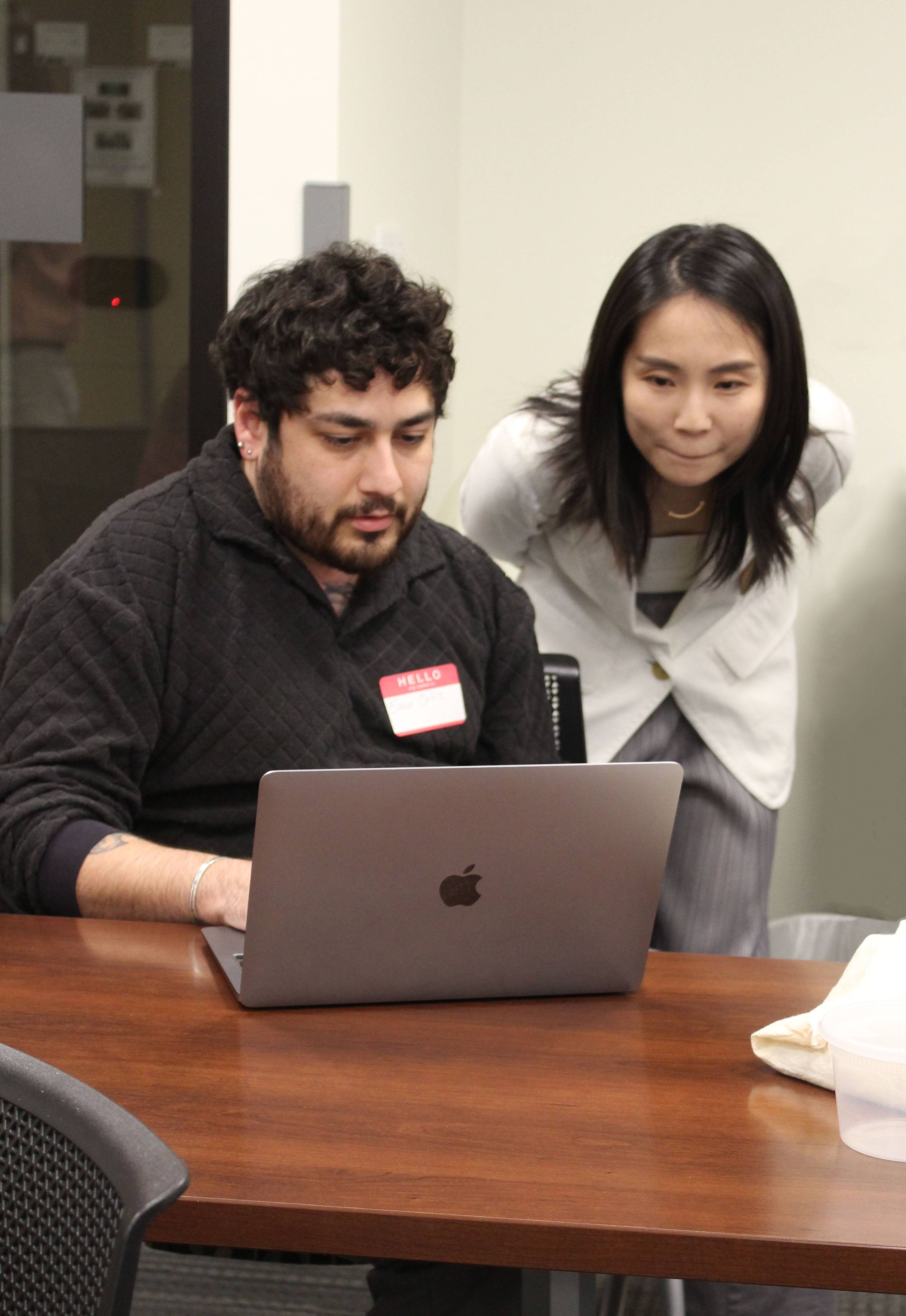 Dr. Xuan Zhou helps student participant