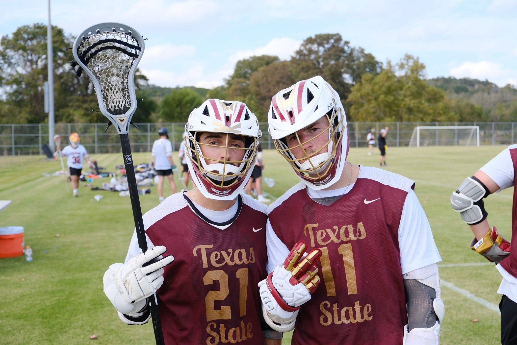 two men's lacrosse sport club members posing during halftime