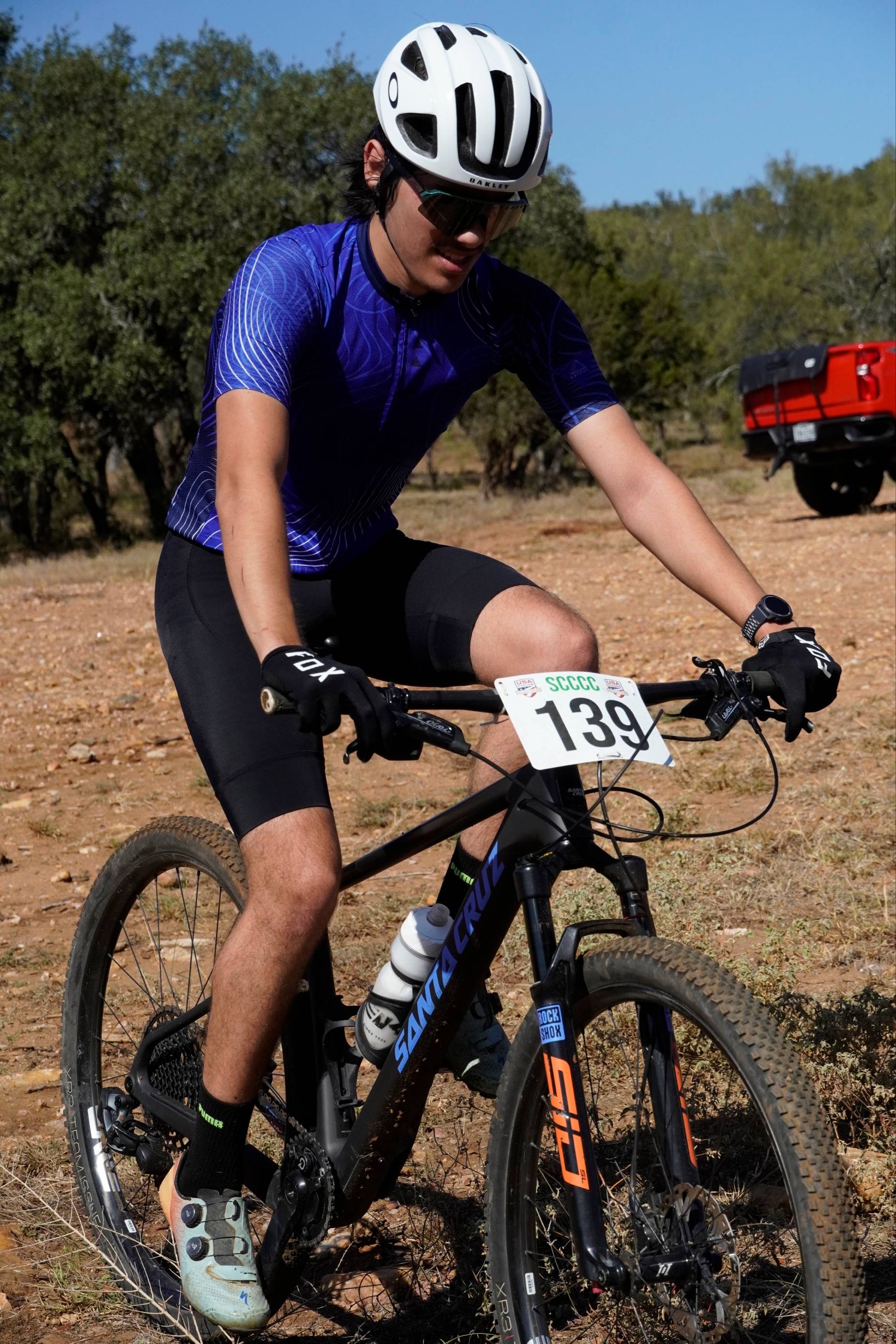 TXST Cycling sport club member preparing for a race on a bike