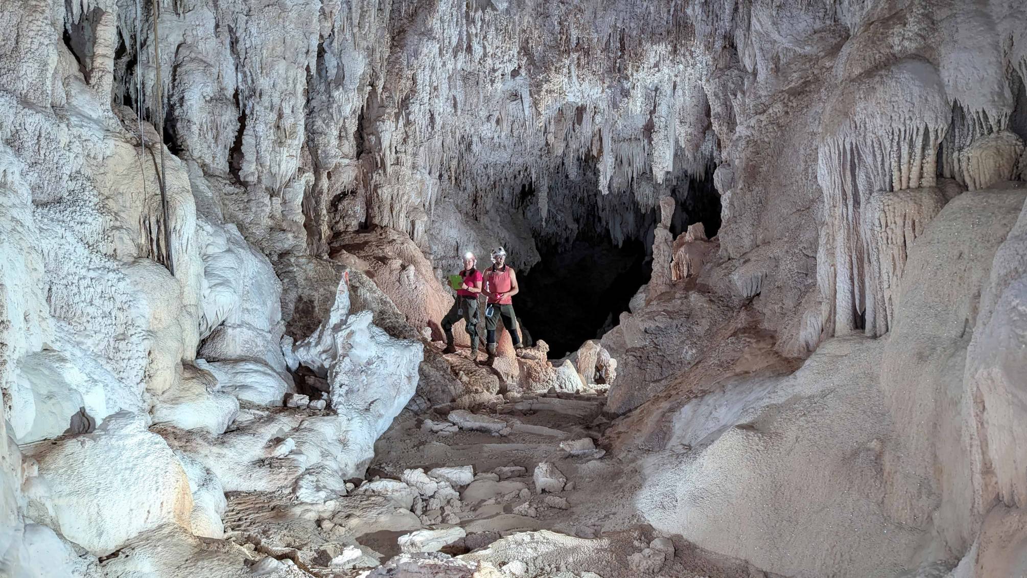 Ben Hutchins and a member of his team pose for a picture in a cave.